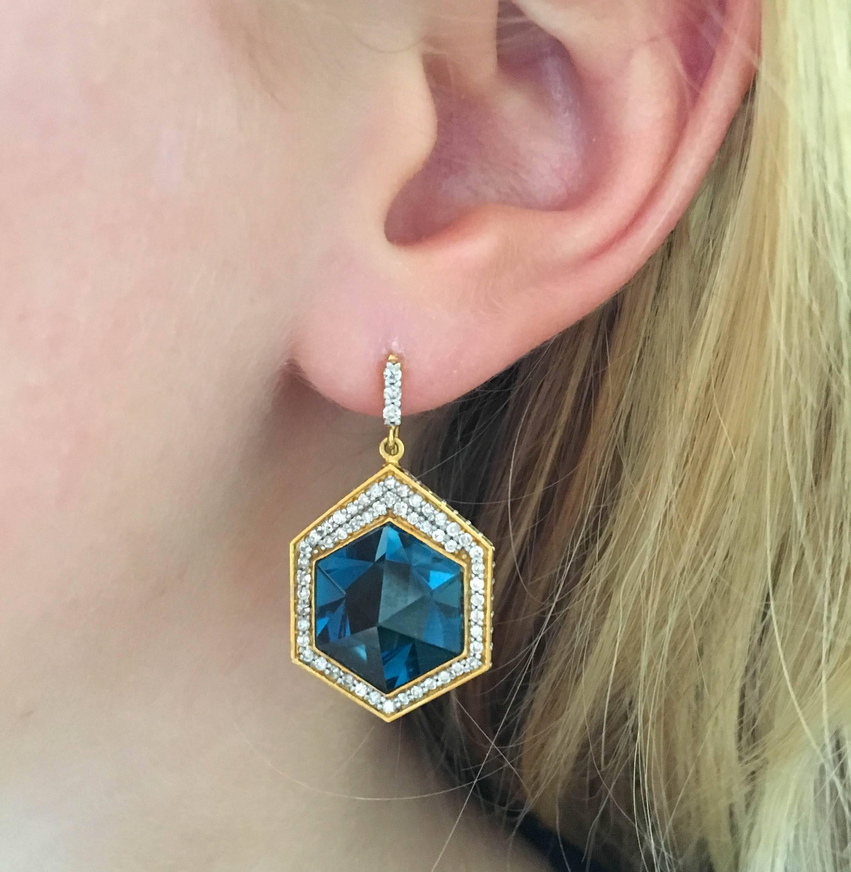 3 Dimensional hexagon pyramids in deep blue London blue topaz, surrounded by 1.41 carats of white Diamonds in 18k Gold.  These earrings are gorgeous from the side as well, and the diamond detailing goes up the ear wire for flattering effect on the