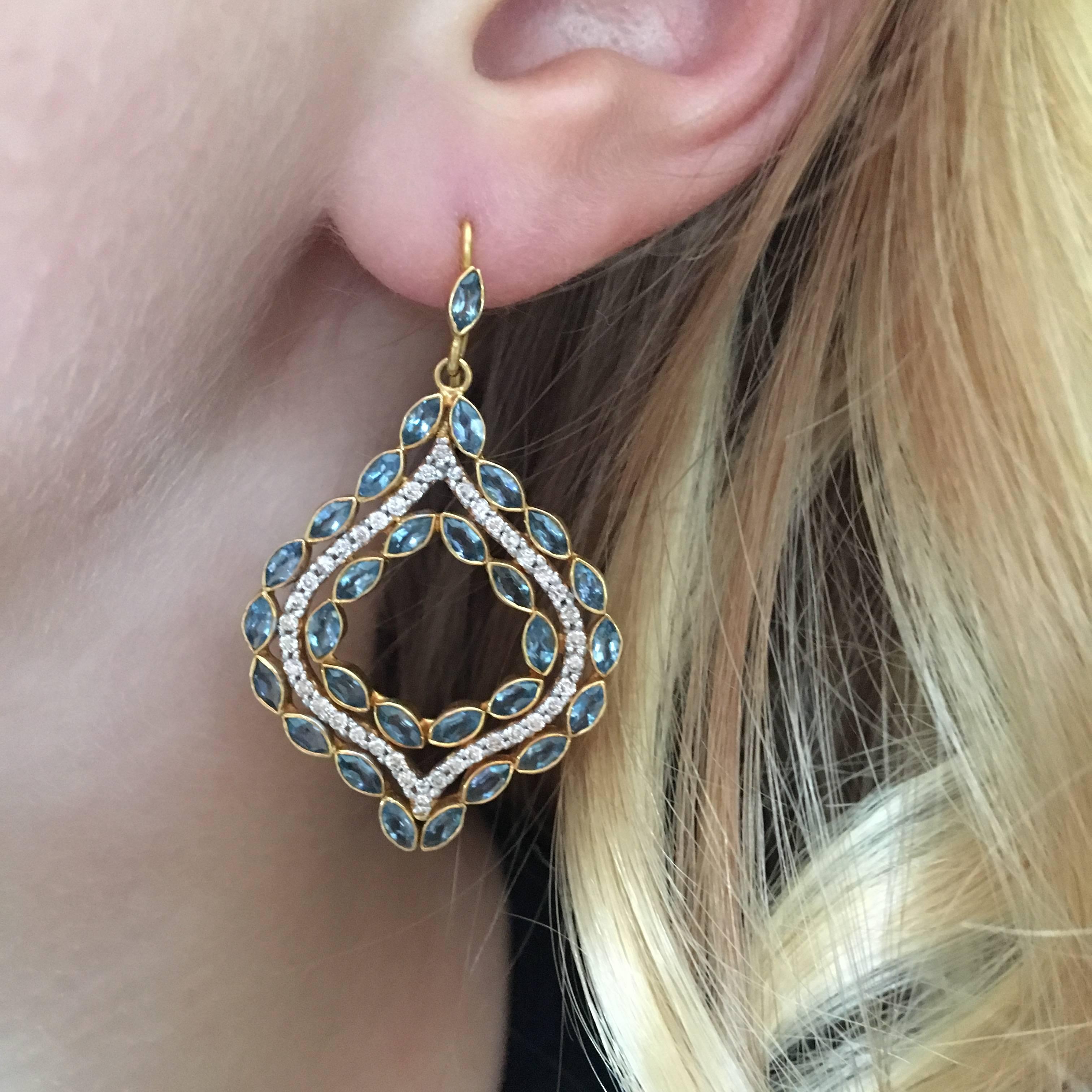 Elegant and lovely, these sparkly .76cts Diamond and Aquamarine Arabesque earrings are sure to get noticed!  Center channel of white diamonds framed by marquis shaped Aquamarines, all set in 18kt Gold in Lauren Harper's signature matte gold finish. 