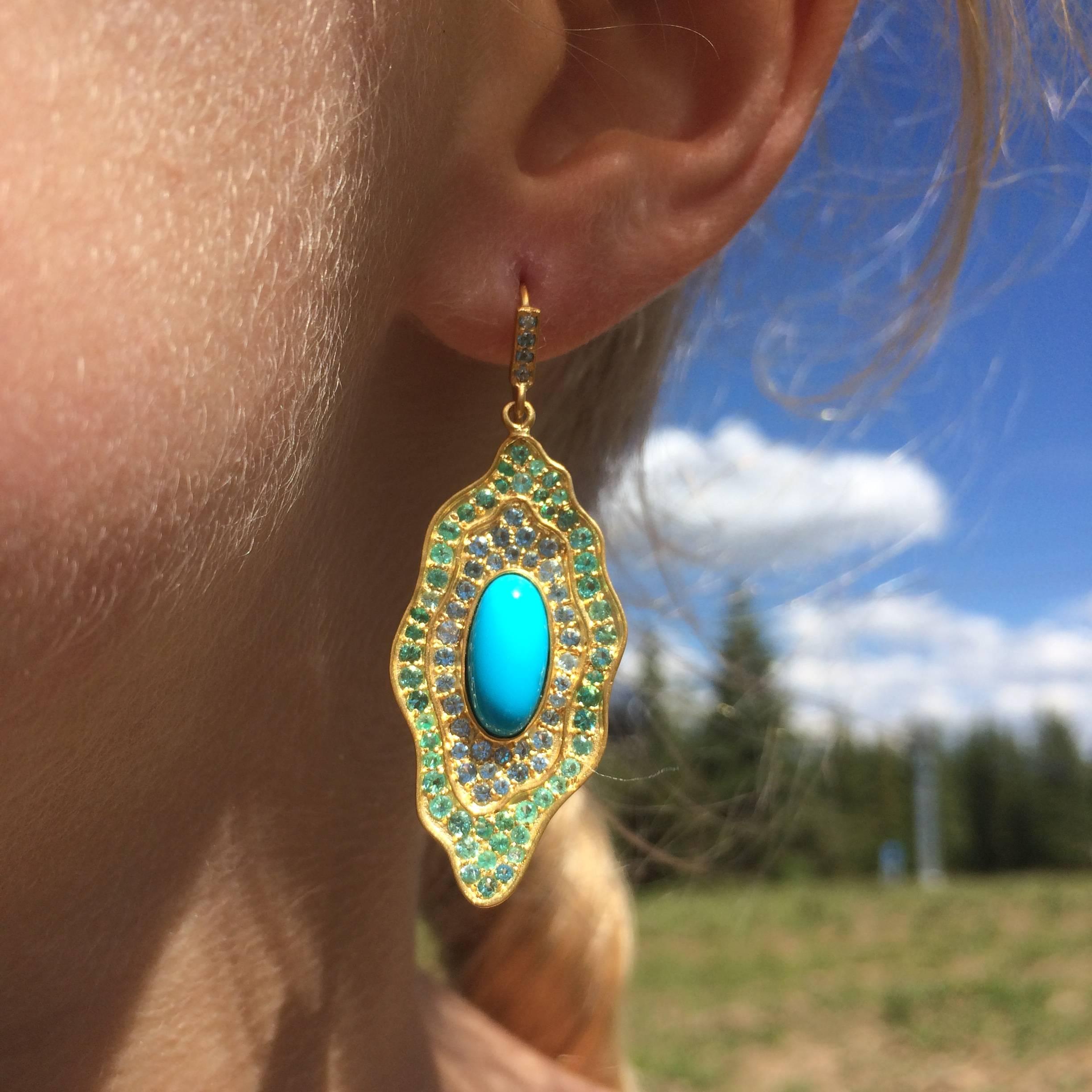 These gorgeous earrings will frame your face with bright and happy color, and ensure lots of compliments!  Organic in design, the outer section is faceted green emeralds, the middle band is beautiful aquamarine, and the center is clean and striking