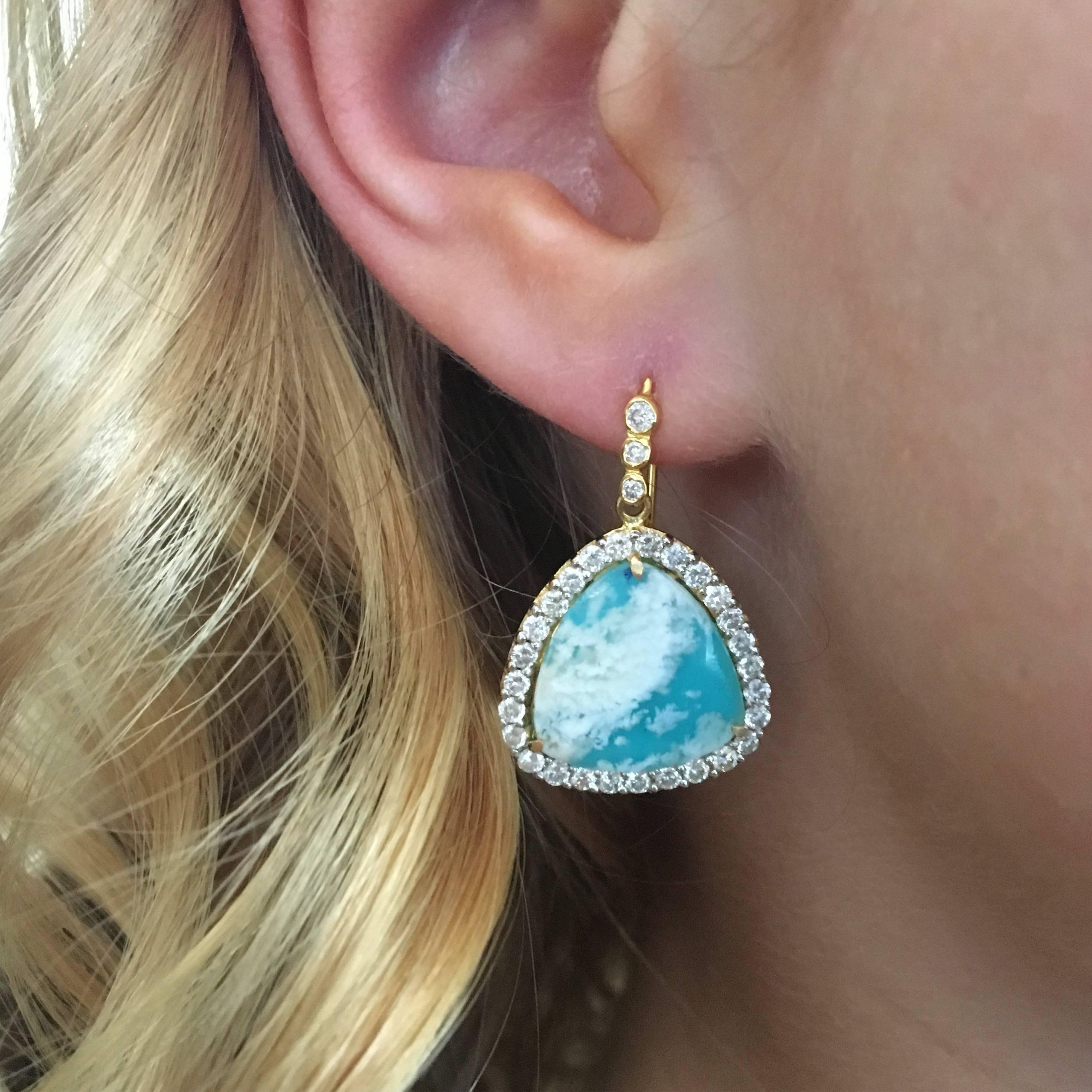 These earrings are truly one of a kind. With translucent sea agate placed perfectly on top of turquoise, these earrings have the appearance of floating clouds in a gorgeous blue sky. White Diamonds in micro pave surround these unusual stones in 18kt