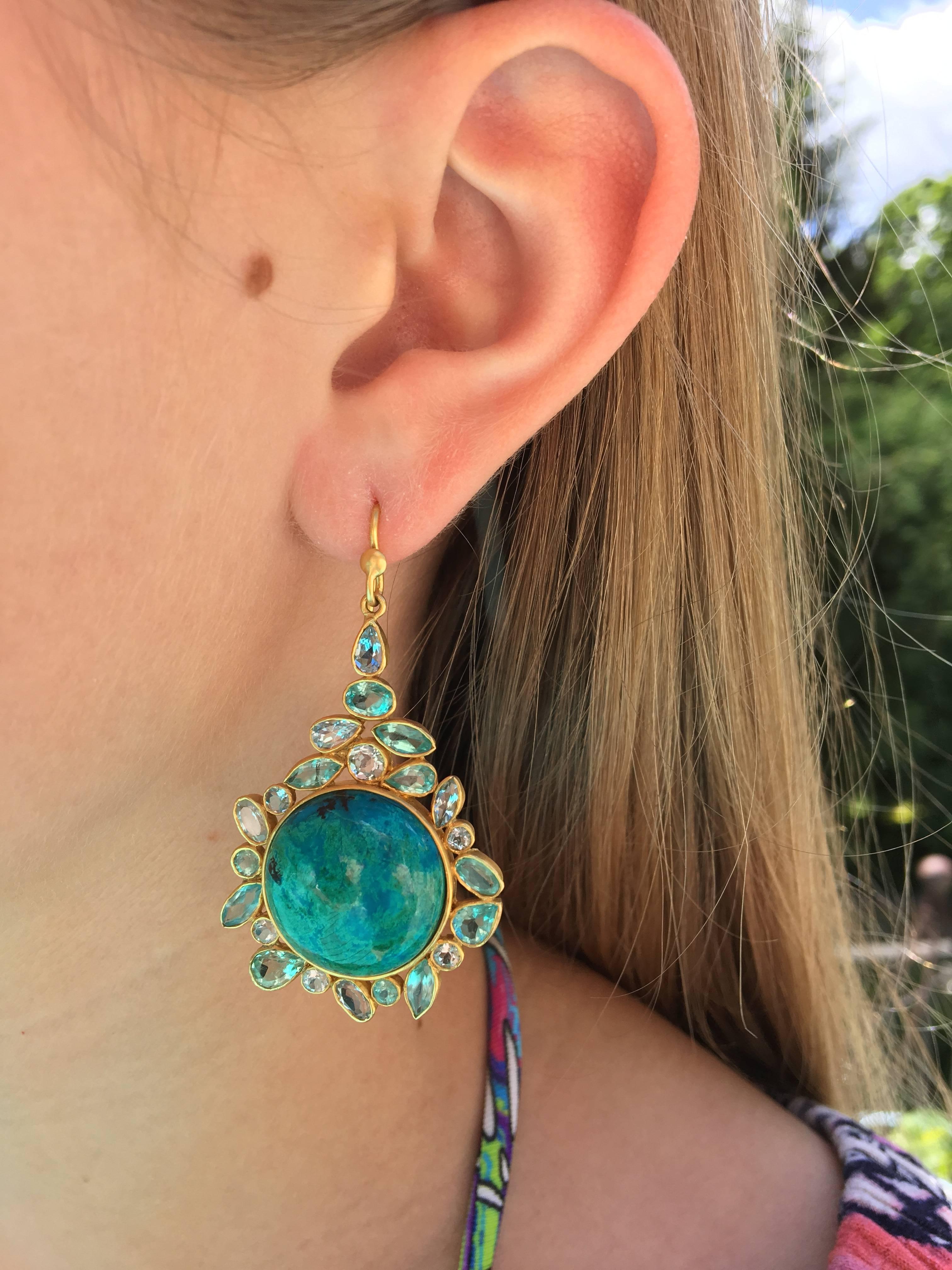 These gorgeous earrings are organic in style, and also offer plenty of color and sparkle.  With a colorful, round cabachon of greenish blue Chrysocolla as a centerpiece, they are surrounded by faceted blues and greens in Aquamarine and Apatite, set