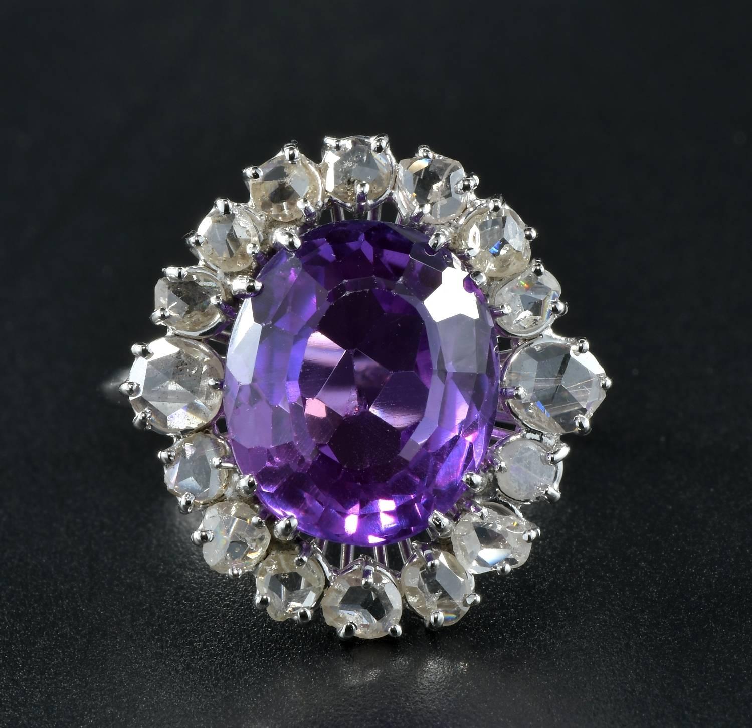Rare large sized 100% Natural Sapphire untreated no heat Purplish with a pinkish hue to it.
Estimate on mounting 11.45 Ct (measuring 14.01 mm. x 11.91 mm.). Stunning antique example!
Complemented by 16 rose cut Diamonds of fine quality totalling