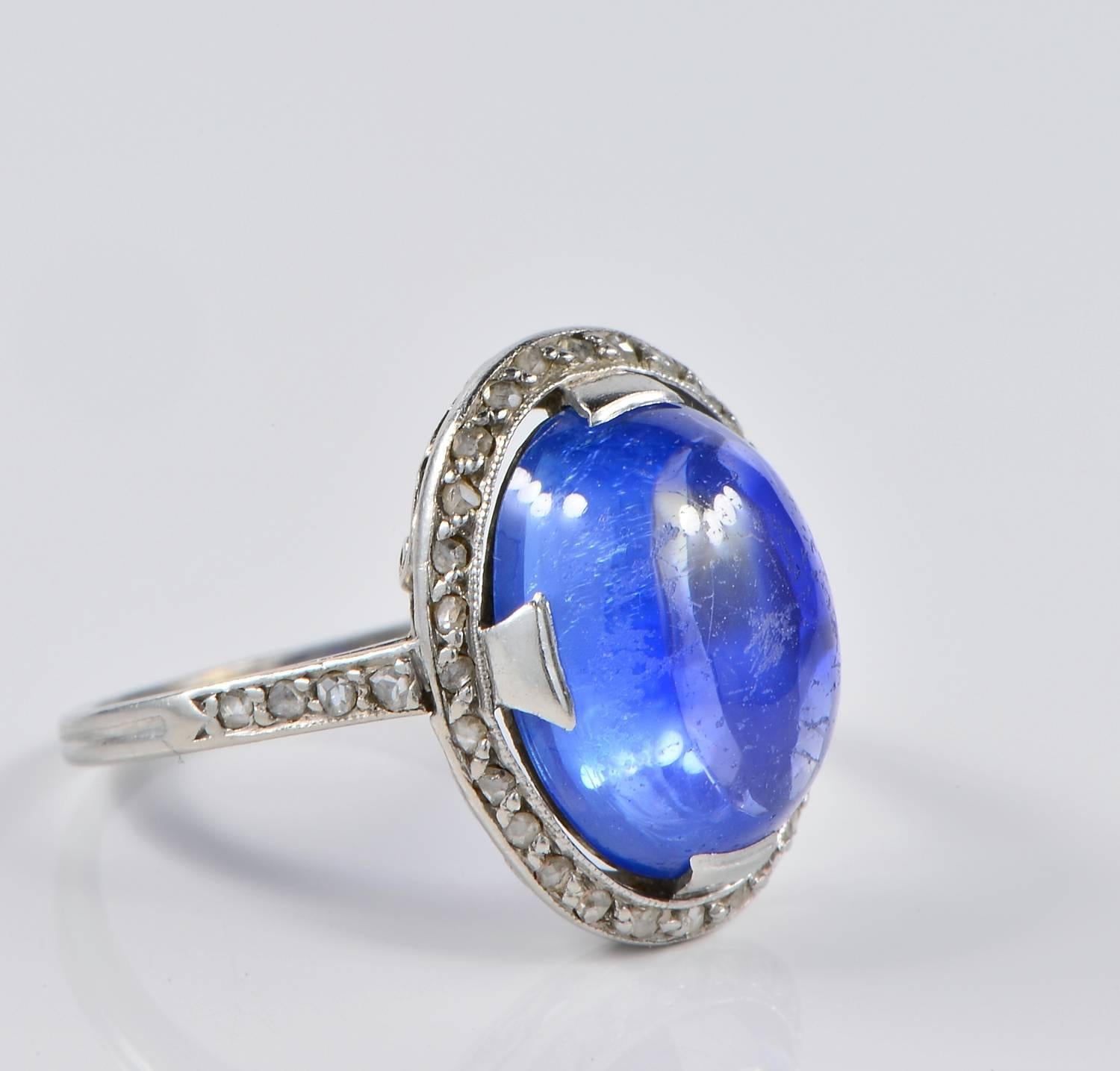 A charming early Deco ring all crafted of Platinum in a delightful design.
Centering a large Natural Ceylon Sapphire cabochon oval cut - estimate 10.0 Ct - measuring  12.70 mm. x 10.20 mm.
Complemented by tiny old rose cut Diamonds adding character
