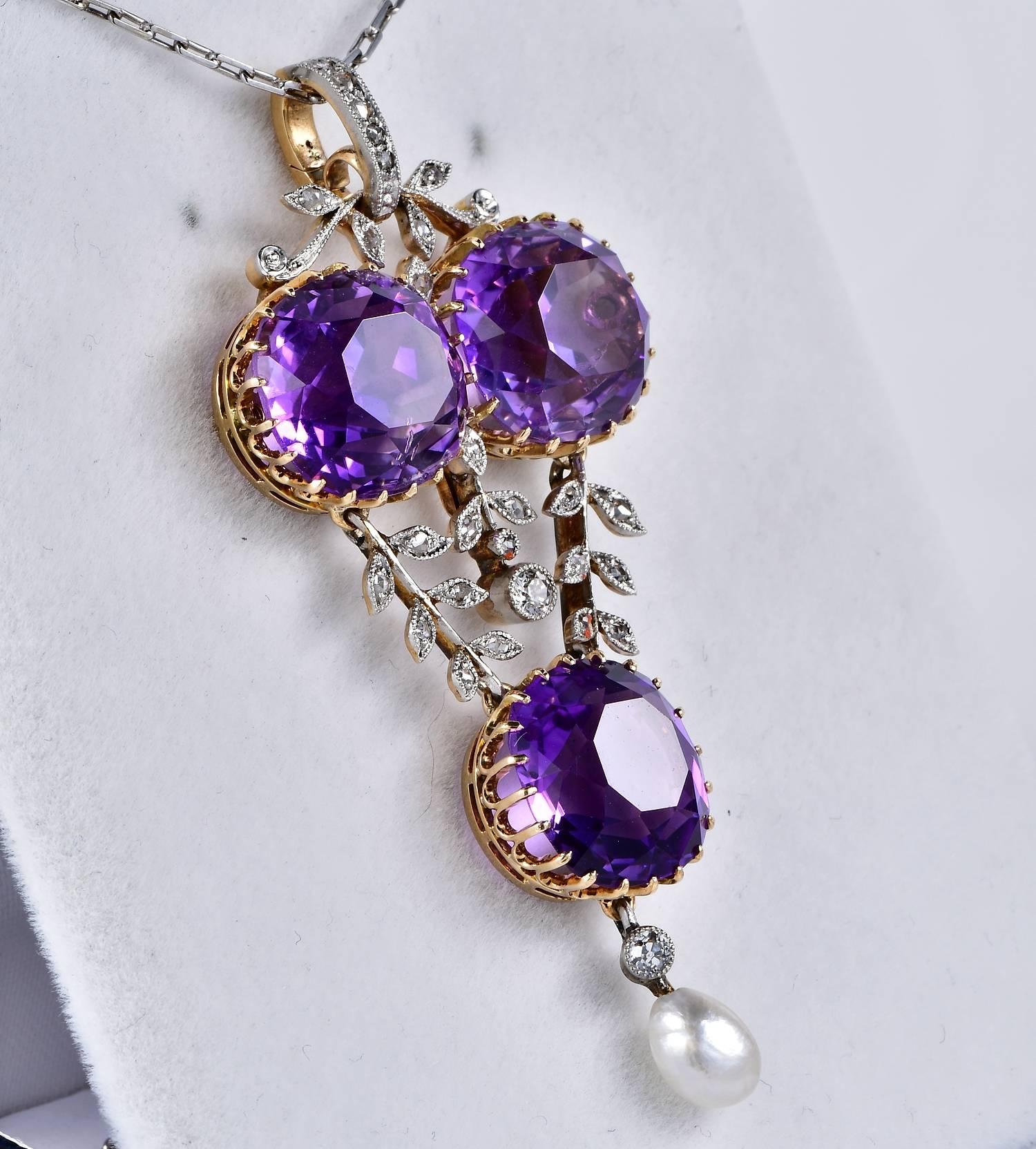 A striking authentic Edwardian natural Siberian Amethyst and Diamond pendant
Hand crafted of solid 18 Kt gold with platinum top. Three large and superb Siberian Amethysts make the focal point of this rare past workmanship. The three large Amethysts