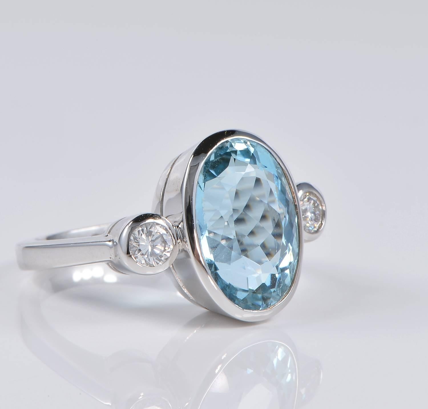 a timeless trilogy style for this stunning Aquamarine and Diamond ring.
Substantially hand crafted of solid 18 kt white gold - marked
Boasting a superb intense Sky Blue natural Aquamarine as main stone weighing 7.0 CT
Complemented by two round