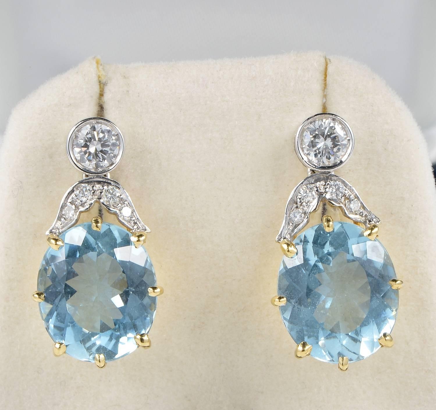 Superb pair of late Art Deco drop earrings.
Designed with a large oval drop of Natural Aquamarine of pleasing sky blue colour complemented by leaf work and a target Diamond set on top.
Hand crafted of solid 18 KT gold except the Diamond set of