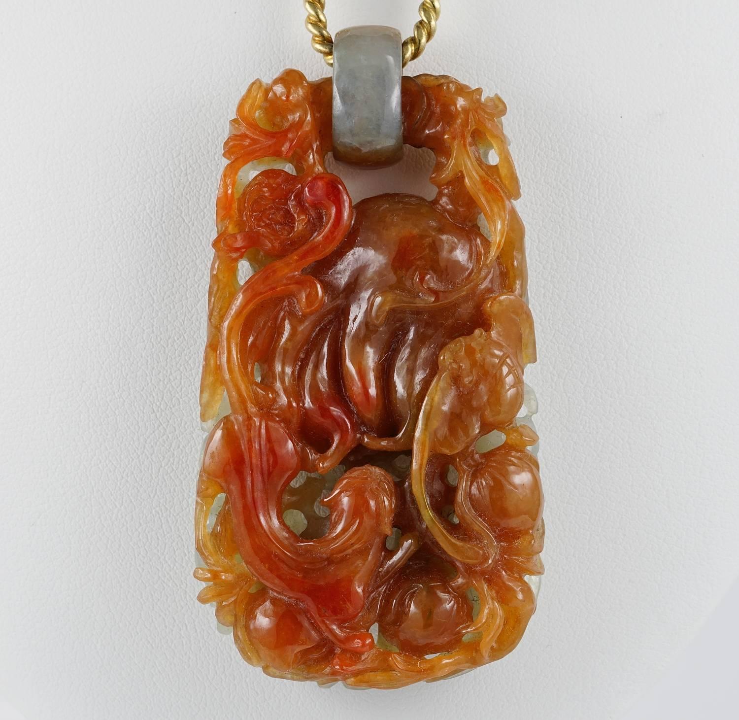 A beautiful antique Chinese origin natural Jade necklace monuted in solid 18 KT gold
The necklace comprises an eleaborate deep carving pendant of Natural not treated Celadon and Russet Jade featuring lots of symbolic subject dear in the Chinese