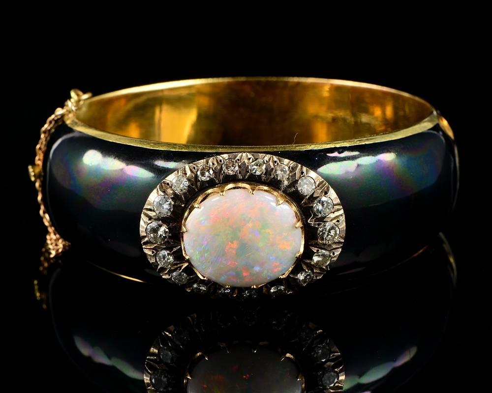 Sorry there was an error in pricing this item
A Striking example of authentic Victorian bangle set with an enormous Harlequin Opal surrounded by Diamonds.
Bangle is of wide measure fully covered by black enamelling remarking the centre piece with