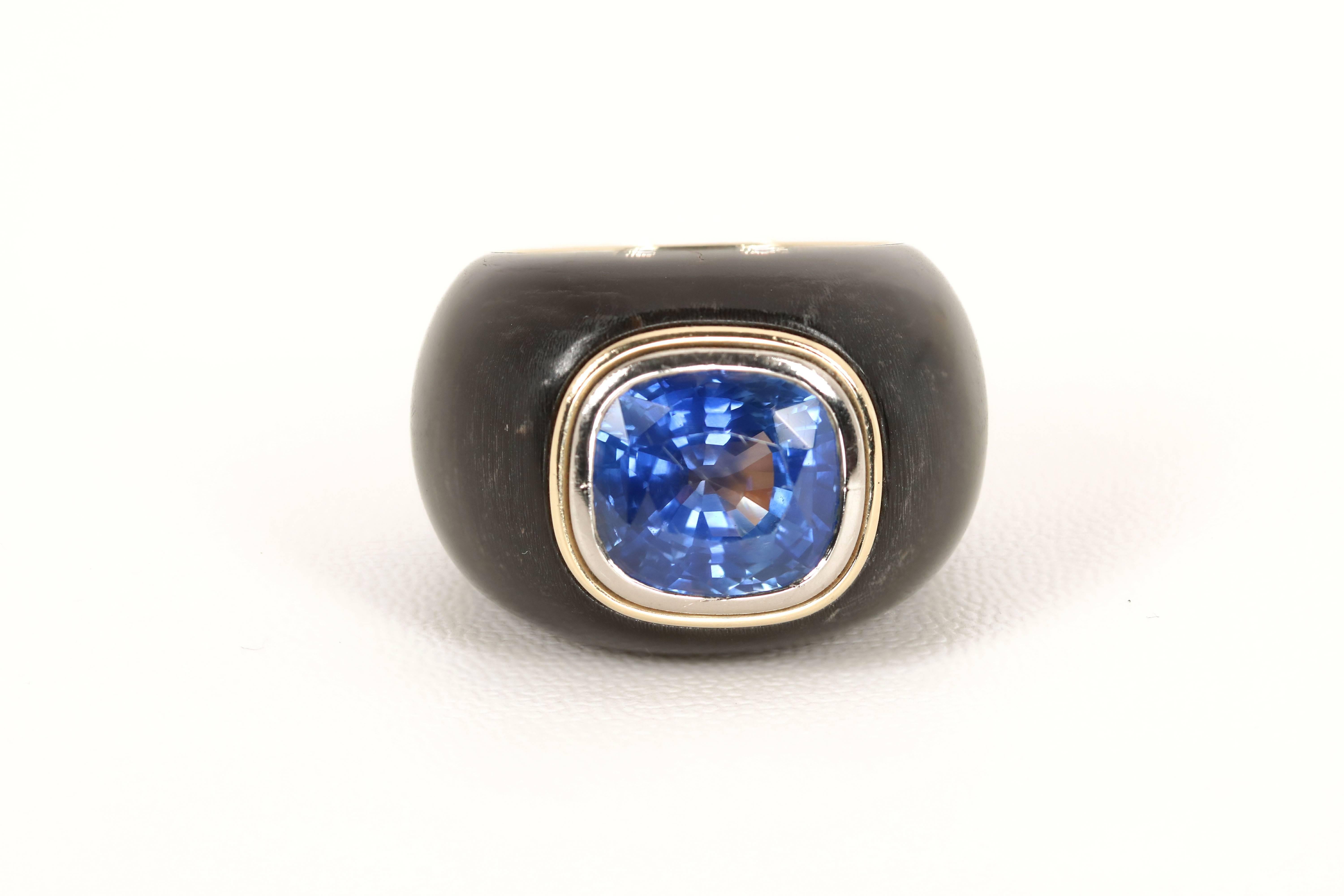 18K yellow and white gold bombé designed wood ring, set with an cushion cut sapphire of approximately 13 carats

AGL Certificate 