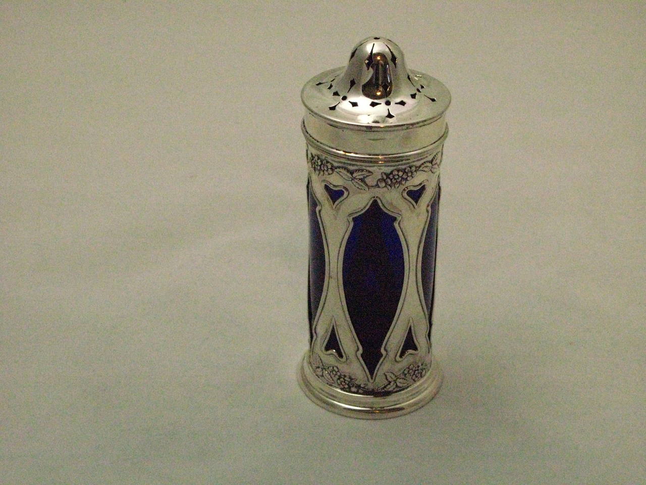 Beautiful silver sugar caster with blue glass lining from the Art Nouveau period.
The caster is hallmarked in Birmingham 1907 and makers marks for Henry Williamson Ltd. The caster is 925/sterling silver.

The caster is circa 15,5 cm high and the