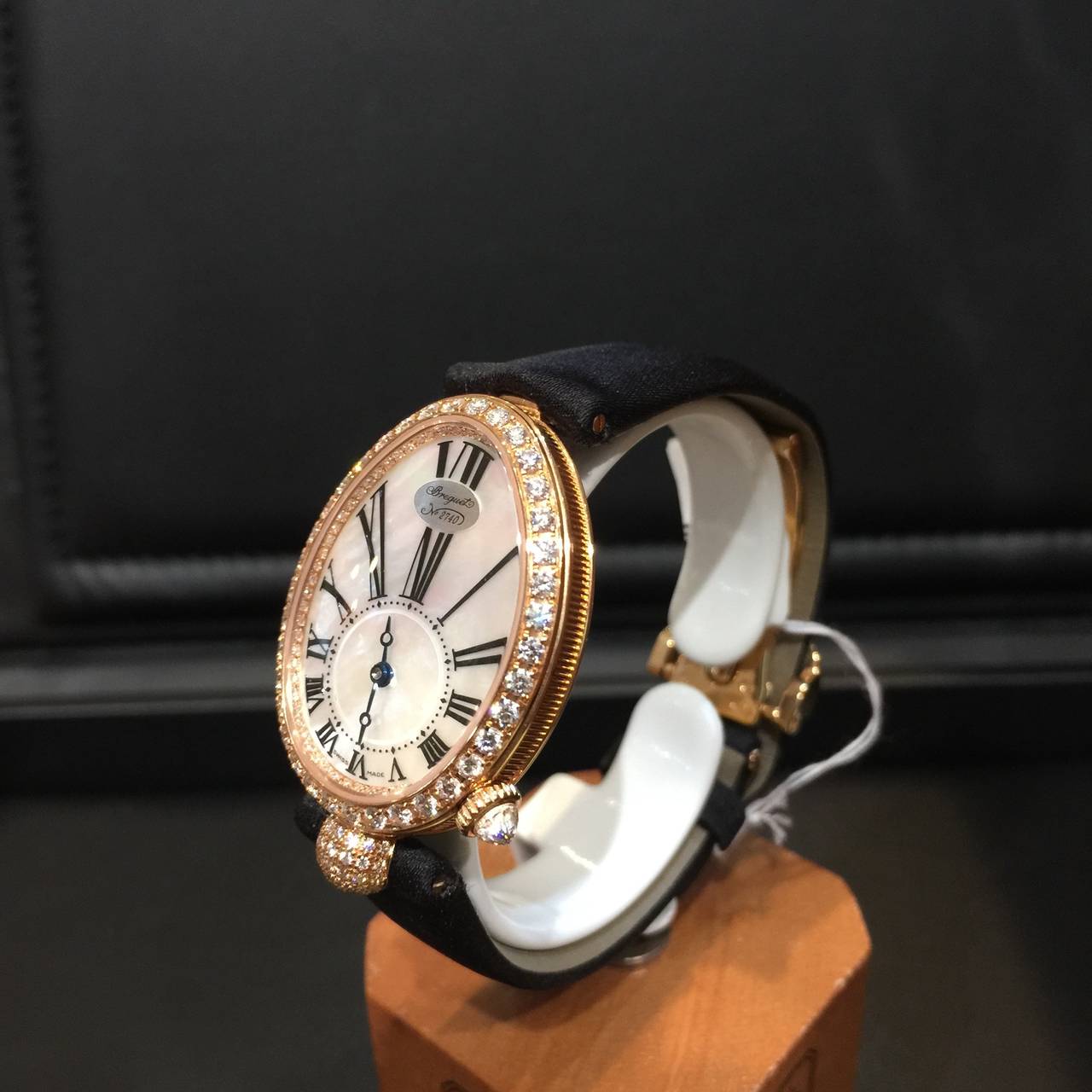 Ladies' Breguet Reine de Naples. Timepiece's dial is made in natural mother of pearl. 

Case is egg-shaped in 18-carat rose gold. Movement self-winding.with fine fluting on the caseband. Bezel, dial flange and ball attachment set with 139 diamonds