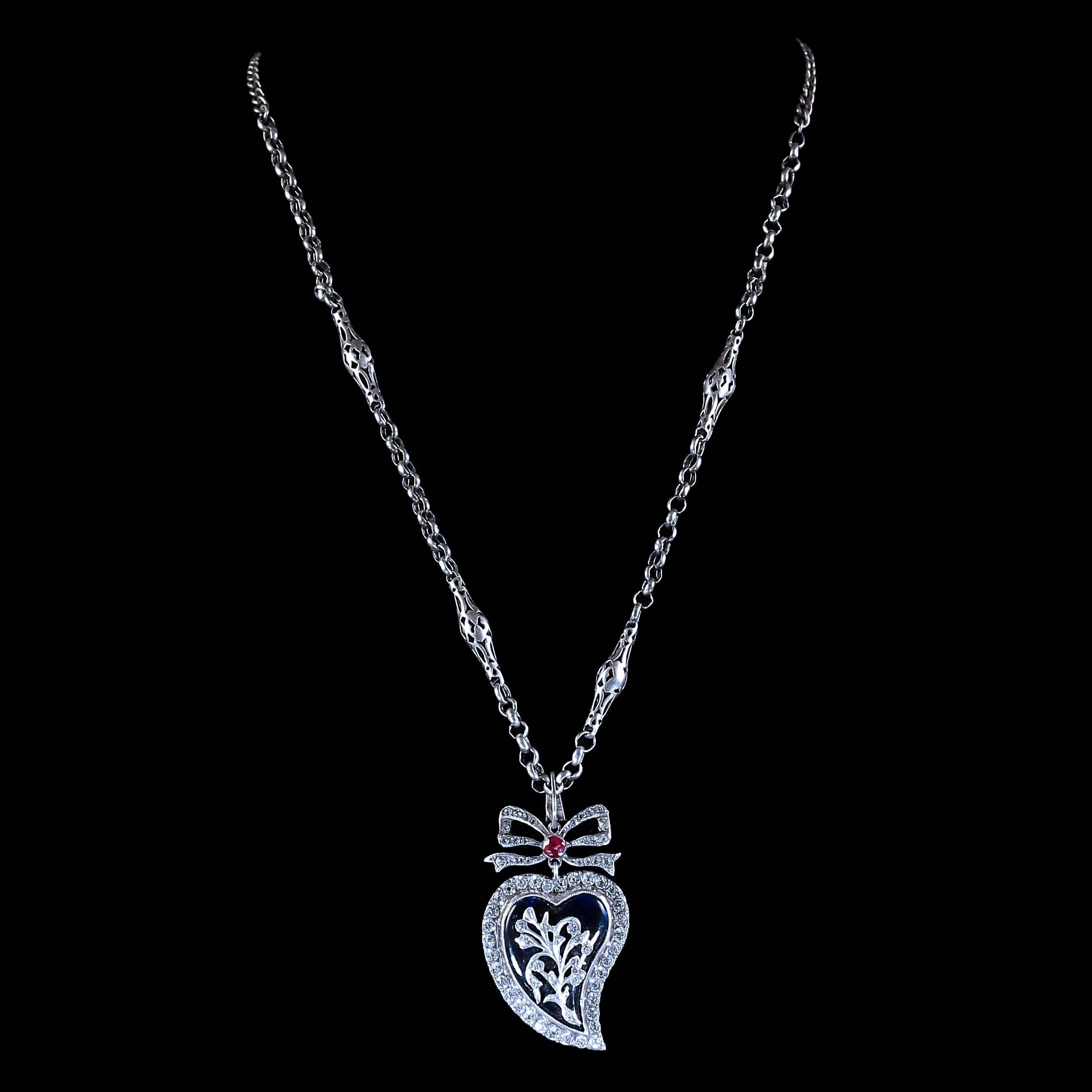 This fabulous Georgian Antique Sterling silver necklace is beautiful set with decorated silver ornate panels that lead to a blue enamel witches heart.
 
A large paste set witches heart that is set with a red paste stone at the top 

The lovely Old