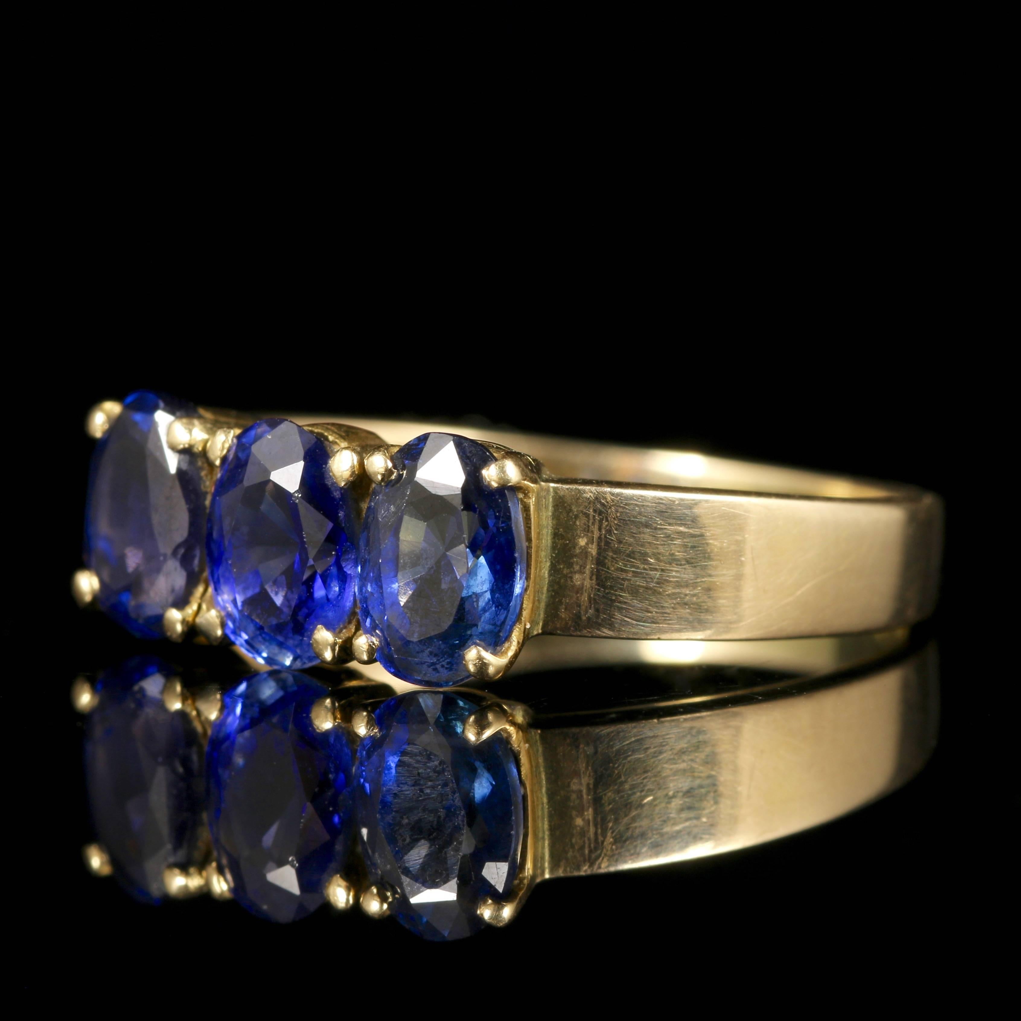 This fabulous Victorian trilogy ring boasts stunning rich Blue Sapphires all set in 18ct Yellow Gold.
A trilogy of Blue Sapphires sits across the centre of the ring complimenting the 18ct Yellow Gold. 
Trilogy stands for past, present, future, or