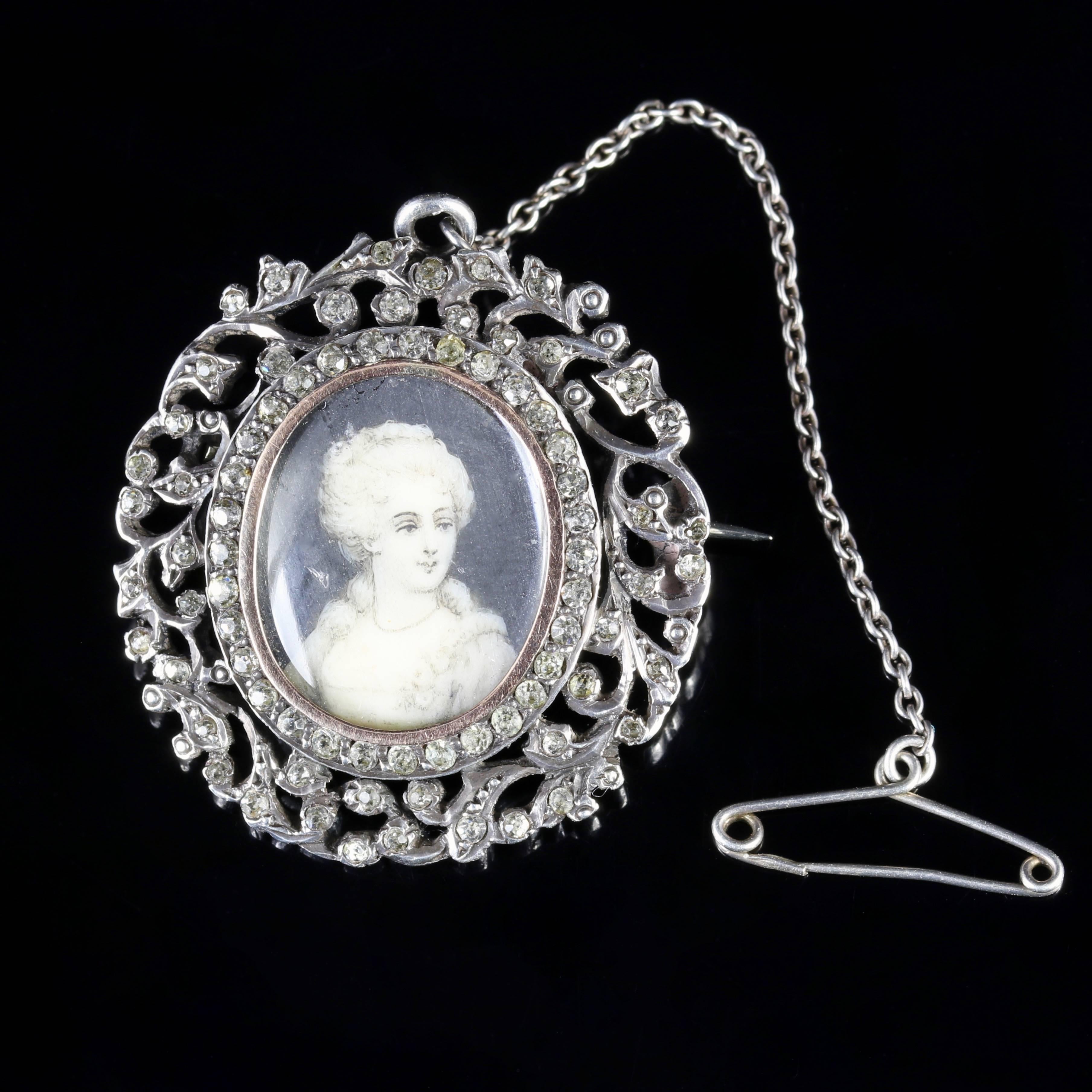 This genuine Antique Georgian Sterling Silver brooch is complete with original box. 

A genuine Georgian piece, Circa 1800.

A hand painted portrait sits in the centre of the brooch showing an elegant lady surrounded by a Gold gallery.

A halo of