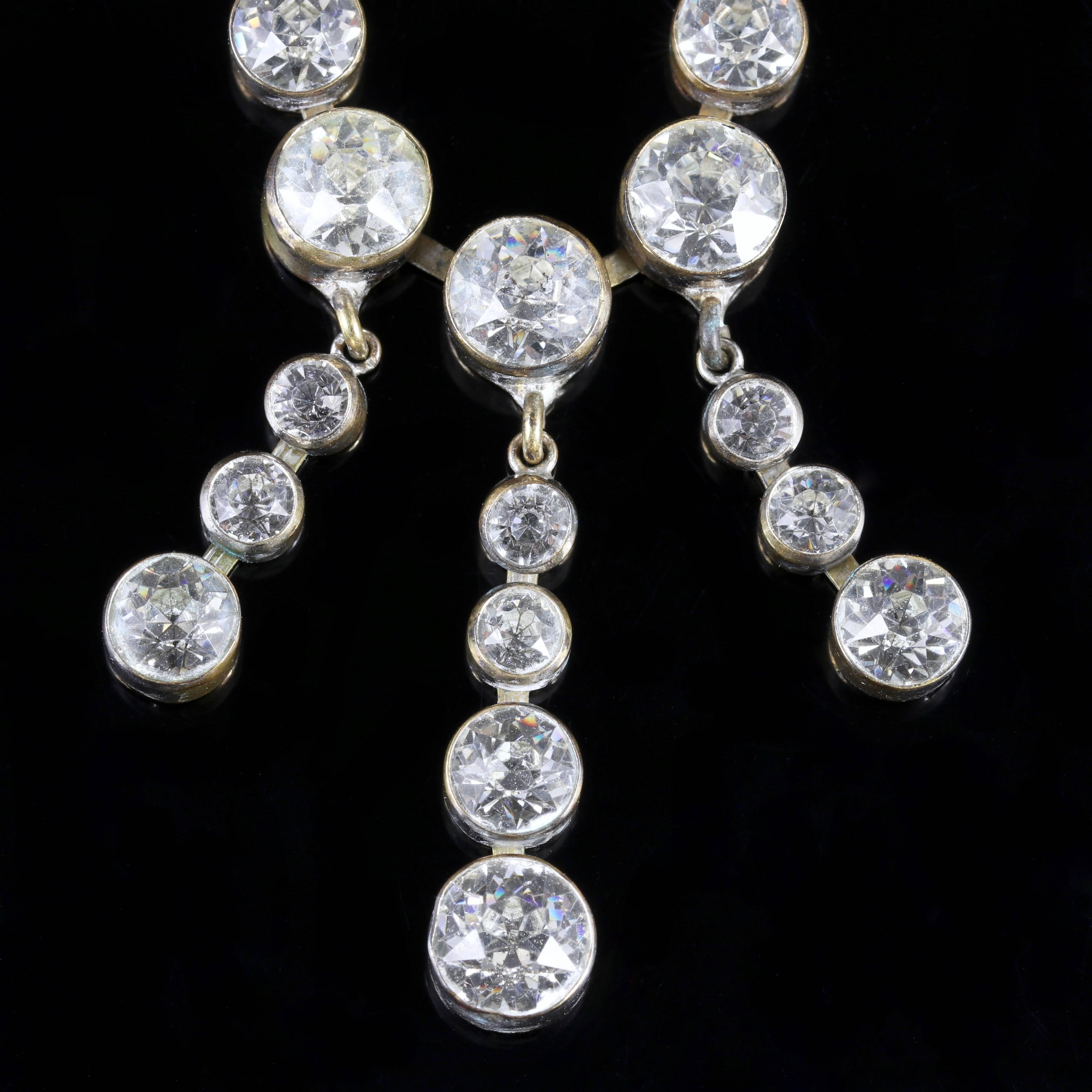 This fabulous long Georgian paste necklace is Circa 1800.

Beautiful old cut white Paste Stones sit in the Silver gallery and sparkle beautifully. 

Paste is a heavy, very transparent flint glass that stimulates the fire and brilliance of gemstones.