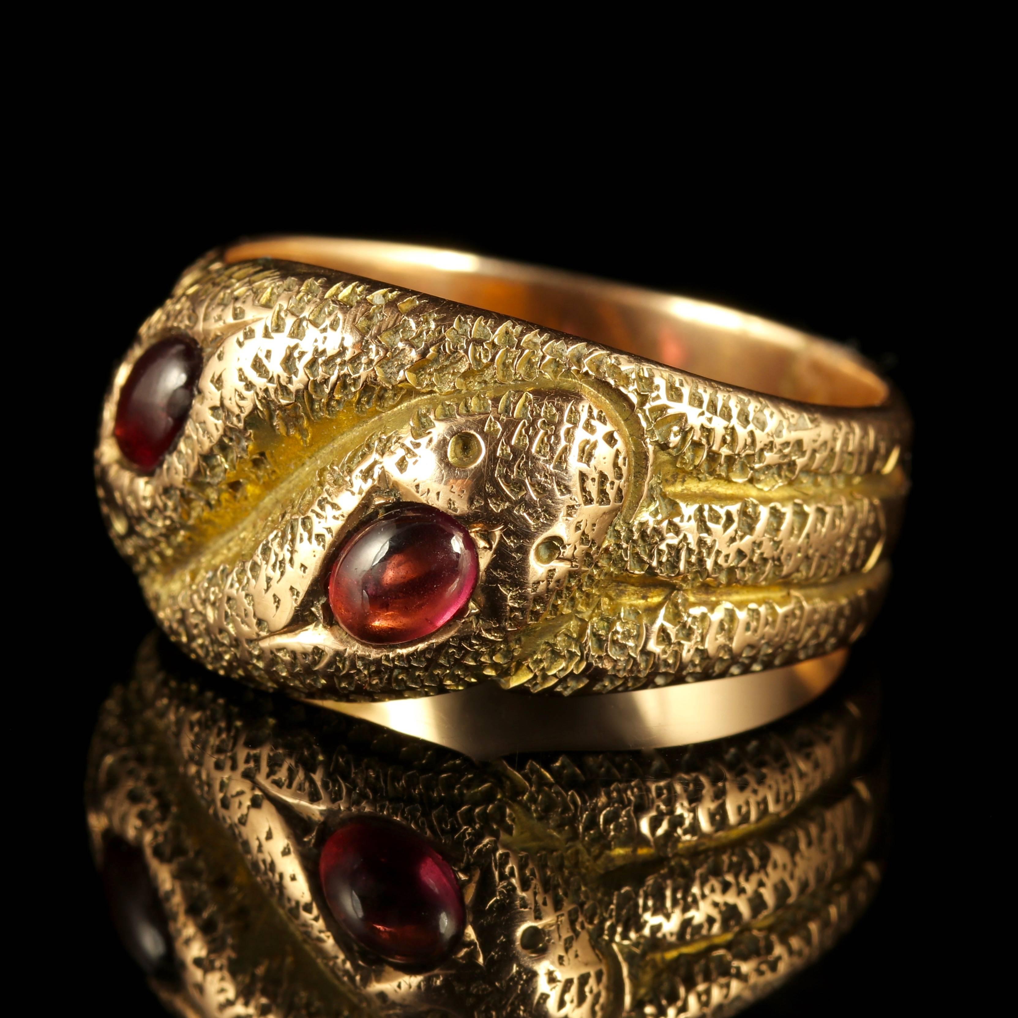 This genuine Art Deco 9ct Yellow Gold triple coiled snake ring is fully hallmarked Chester 1920.

Set with Almandine Garnet stones, cabochon cut and crowned on top of each serpents head.

Almandine Garnets have a lovely rich red hue with a flash of