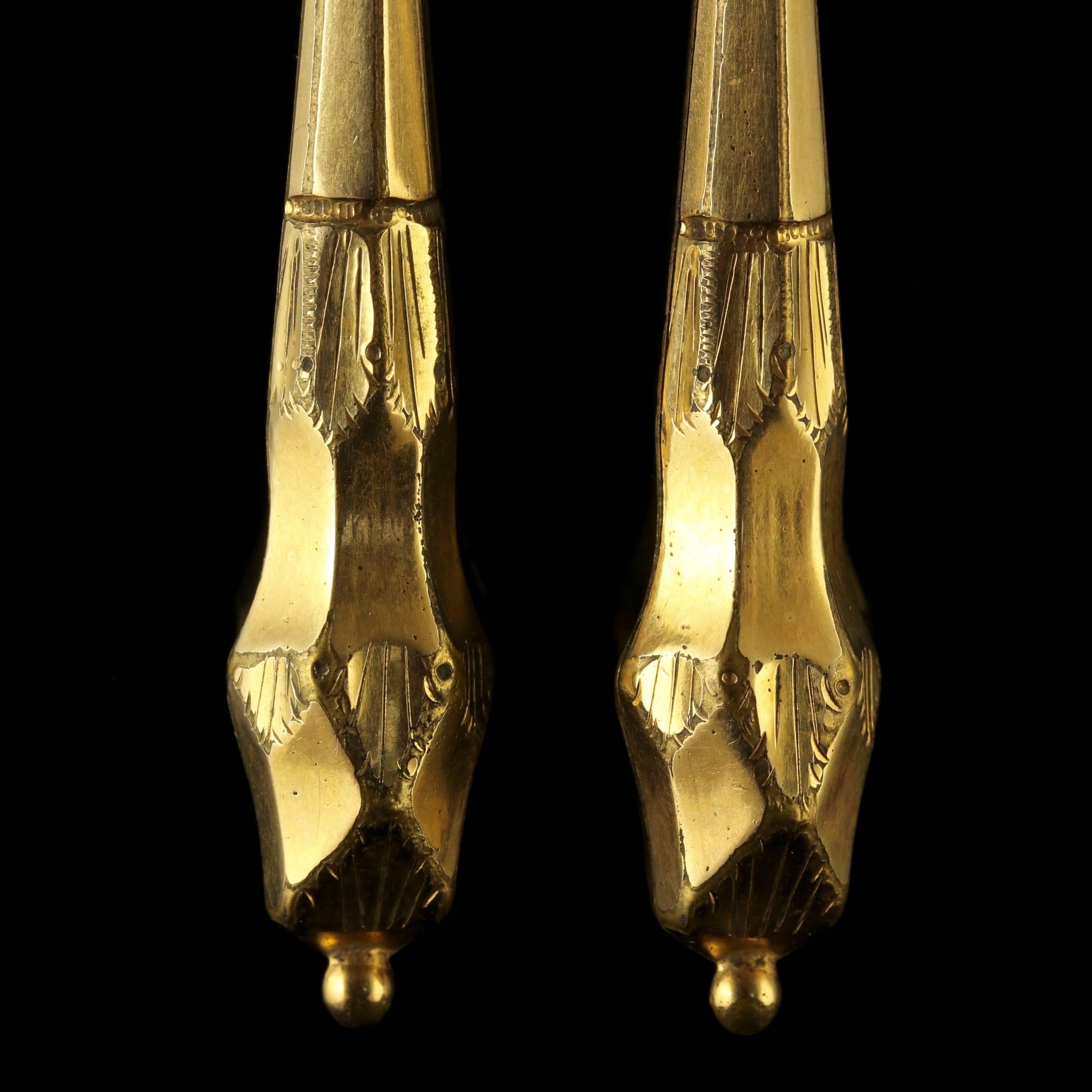 These genuine antique long 18ct Gold Gilt earrings are Circa 1900.

Fabulous detailed engravings are decorated on each earring with pristine Victorian workmanship. 

Beautifully made with faceted pendant bottoms and set on newer 9ct Yellow Gold