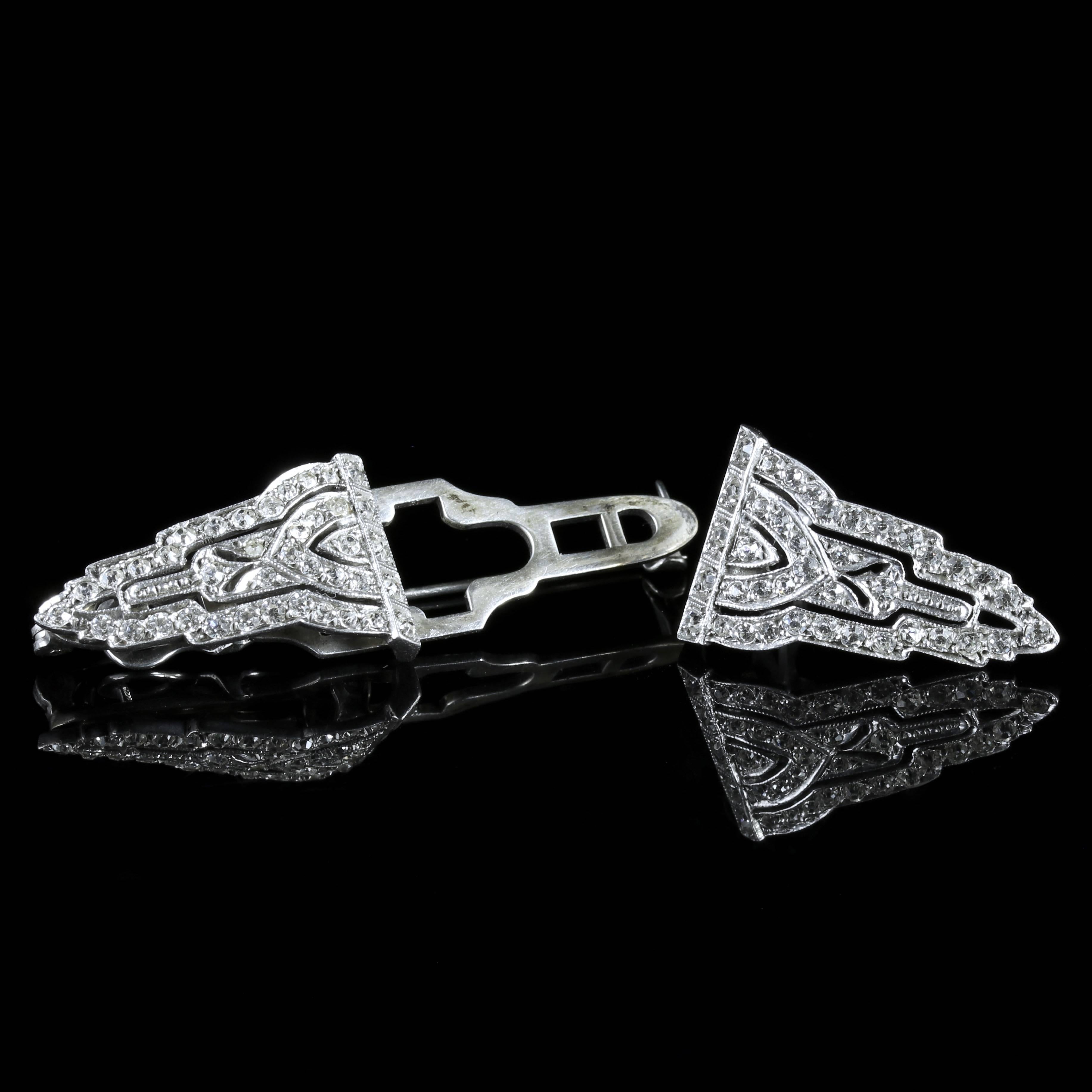 This beautiful Sterling Silver Art Deco double clip brooch is genuine 1920. 

This unique Brooch has two detachable clips that will look fabulous on a lapel.

Each clip is adorned with white Paste Stones which sparkle as they catch the light.