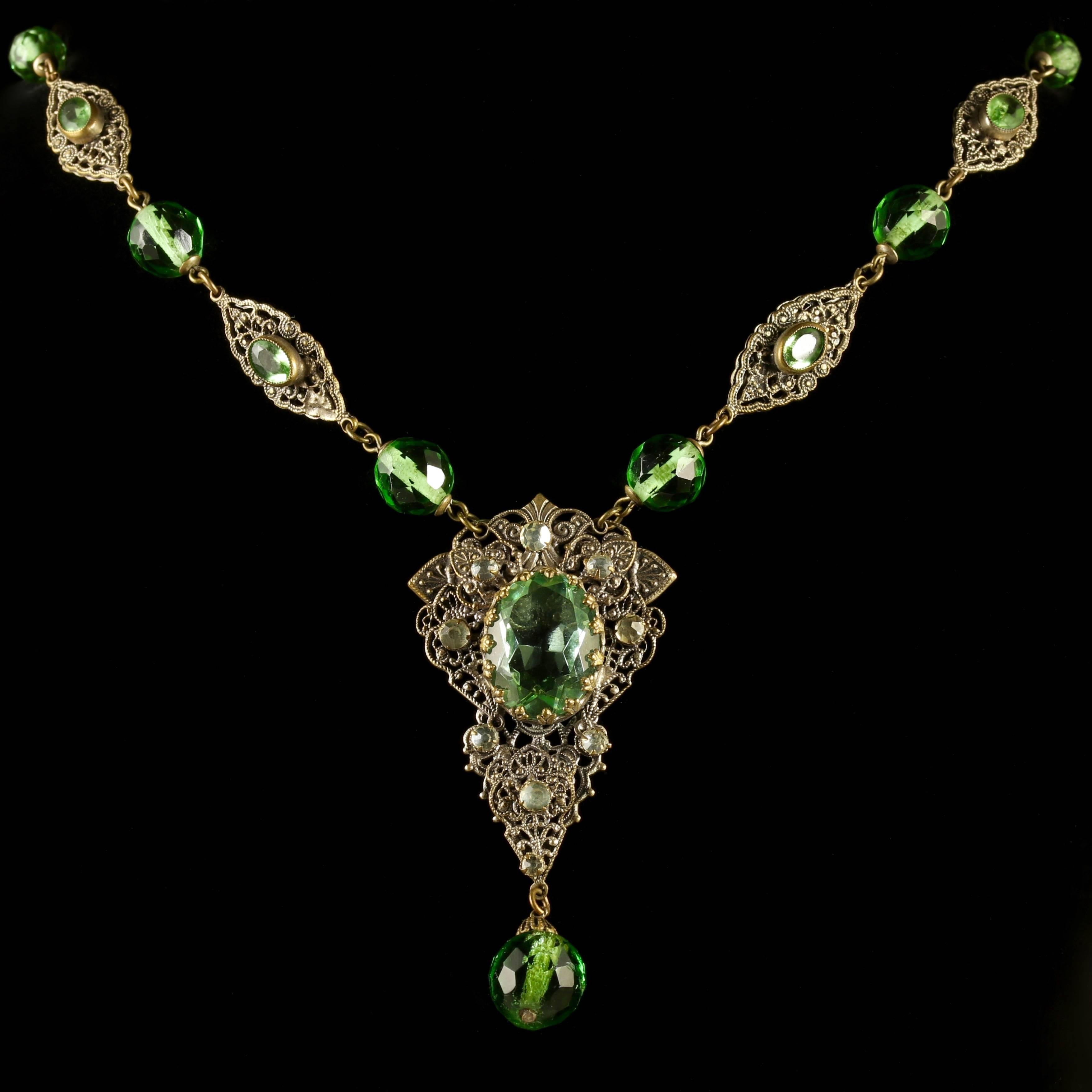 This fabulous Filigree antique necklace is adorned with lovely large green Paste Stones. 

A genuine Victorian piece, Circa 1900. 

The large pendant has a beautiful central green Paste Stone and dropper which is surrounded by a halo of brilliant