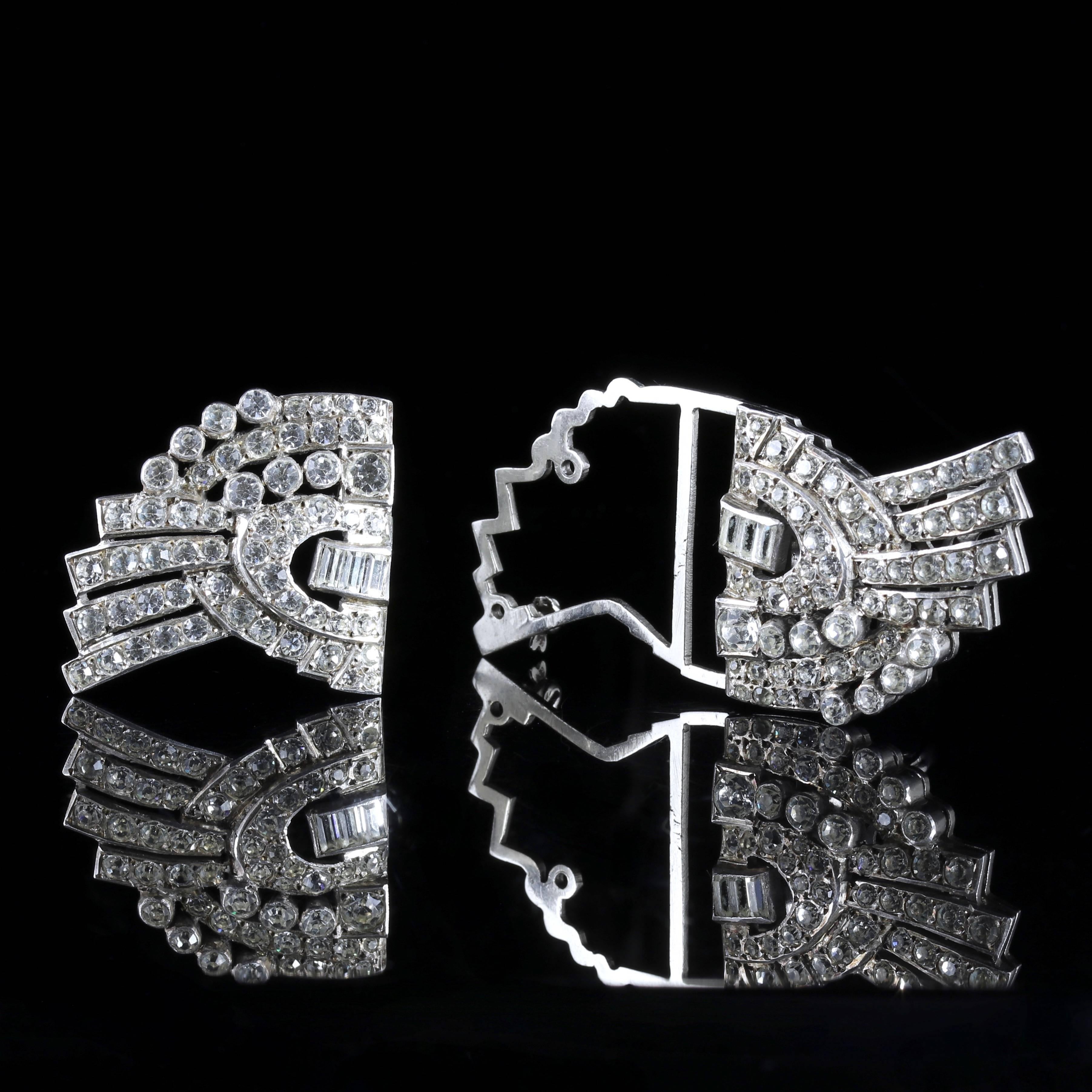 This beautiful large antique Sterling Silver Art Deco double clip brooch is genuine 1920. 

This unique Brooch has two detachable clips that will look fabulous on a lapel.

Each clip is adorned with beautiful white Paste Stones with baguette cut