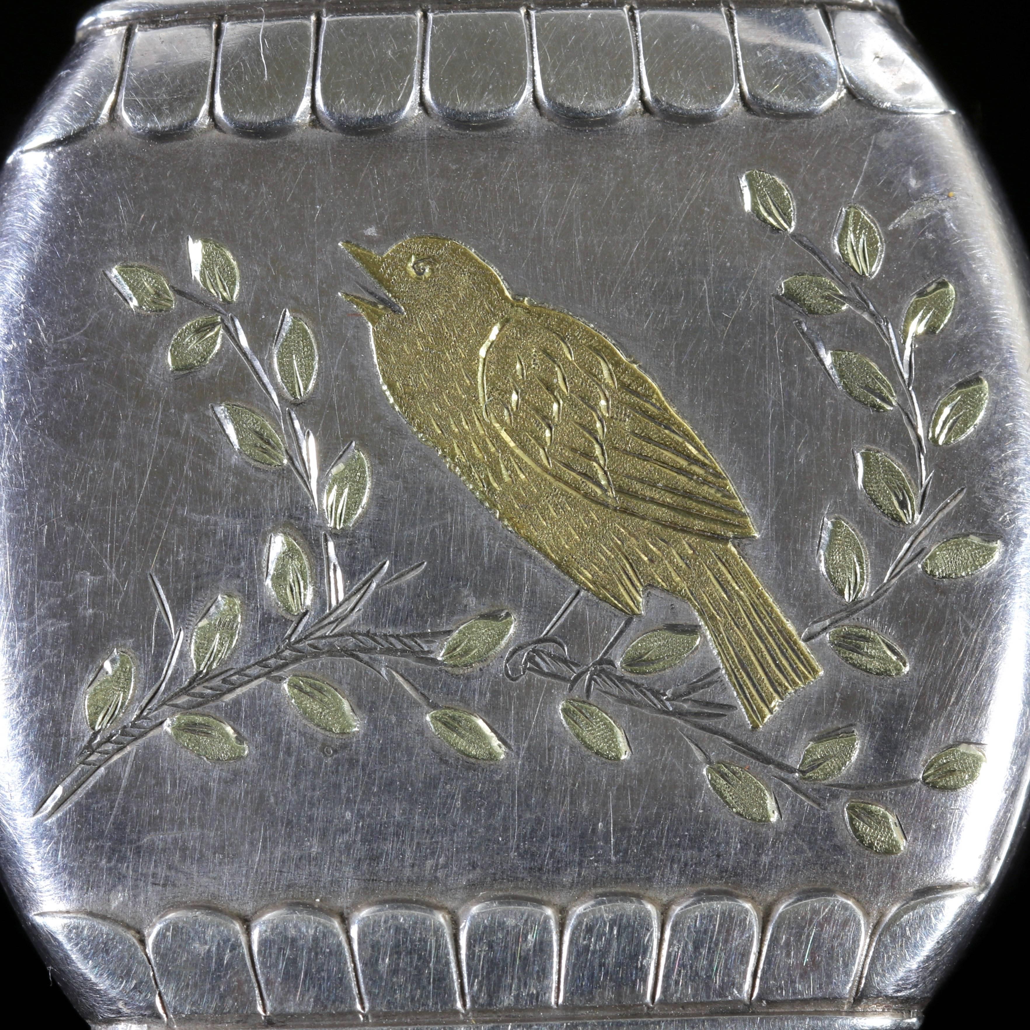 This fabulous Victorian Sterling Silver and Gold locket is hallmarked Birmingham 1876.

A lovely 18ct Gold bird sits in the centre on a branch tweeting his heart out.

Birds are a symbol of love, fun and affection during the Victorian Era.

A lovely