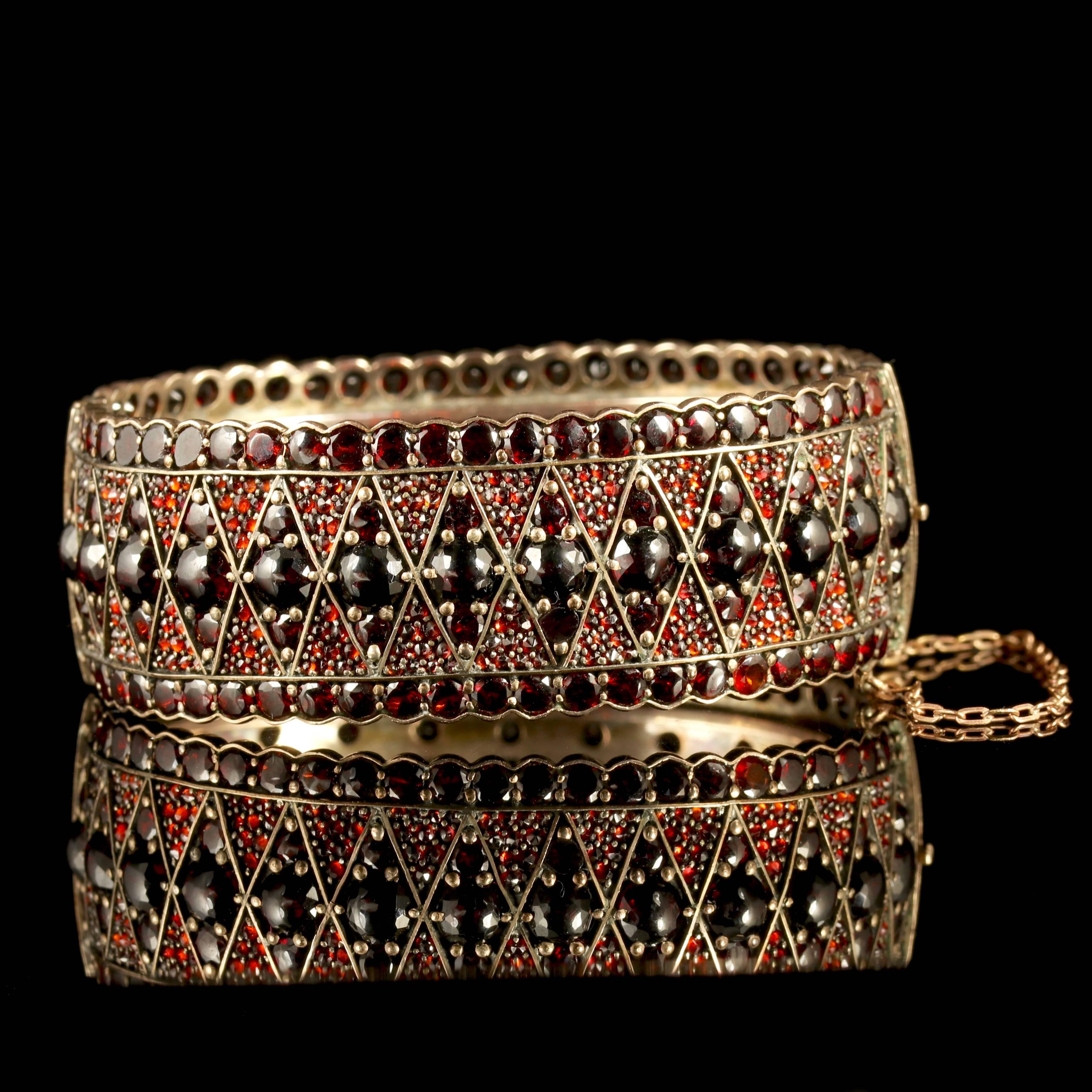 This has to be one of the most stunning boxed Bohemian Garnet bangles we have ever exhibited for sale.

Genuine Victorian, Circa 1880.

The Garnets cascade all the way around the bangle, displaying spectacular beauty and pristine detailed