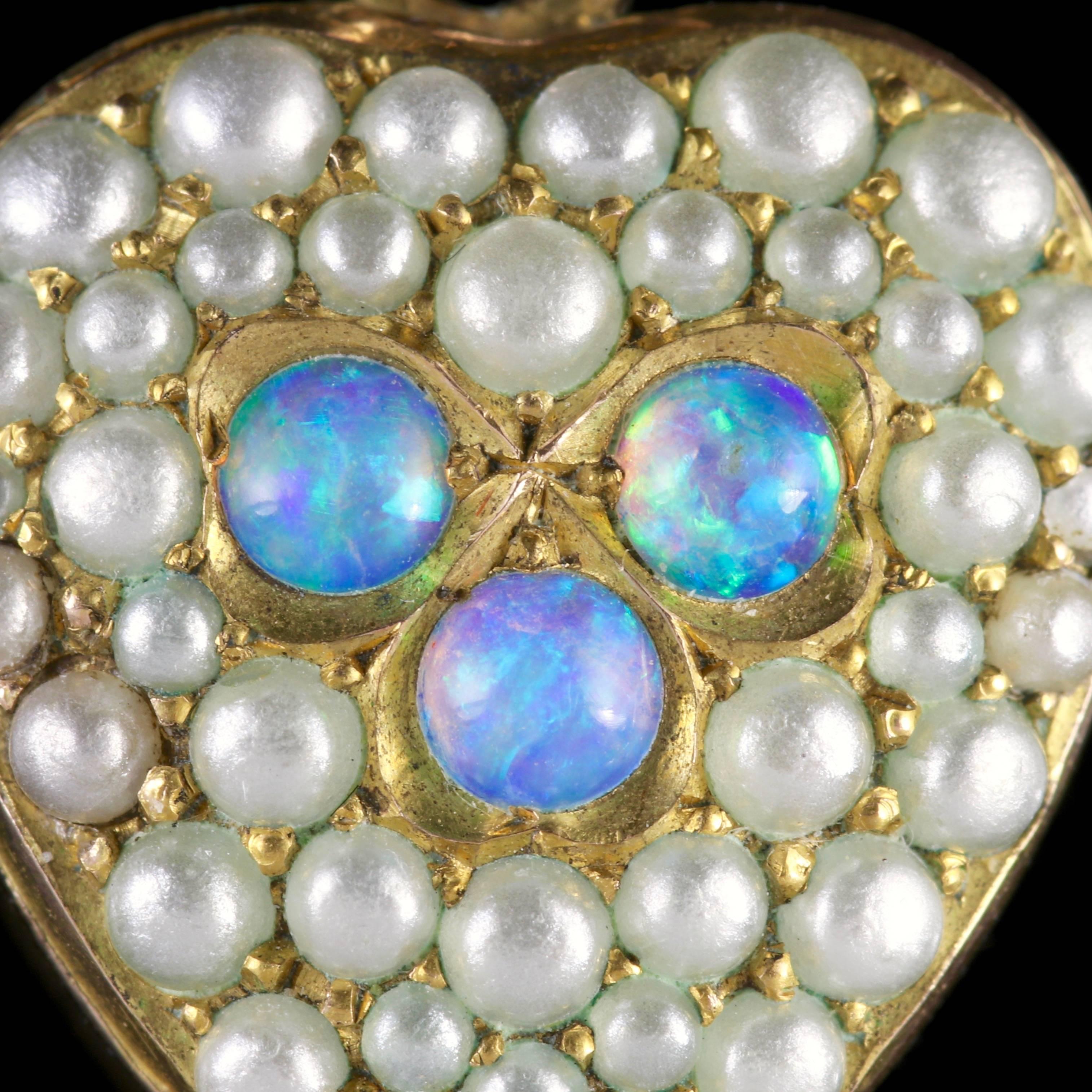 To read more please click continue reading below-

This genuine antique Victorian 15ct Yellow Gold heart is adorned with Pearls and lovely natural Opals, Circa 1890.

Three beautiful Opals sit in the centre of this fabulous heart complimented by