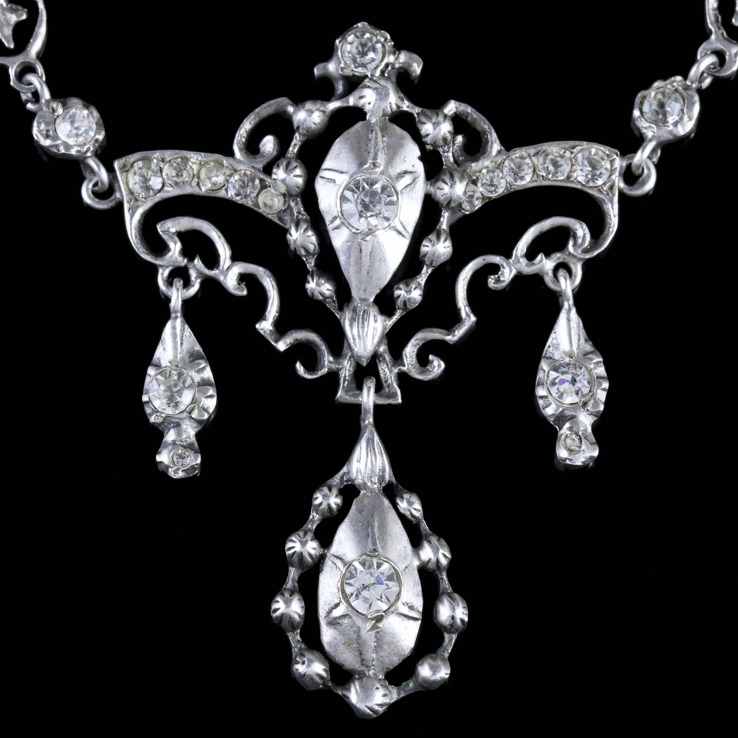 To read more please click continue reading below-

This fabulous antique Sterling Silver Paste Necklace is genuine Victorian Circa 1900. 

The beautiful necklace is adorned with sparkling White Paste stones leading to a fancy Paste pendant with 3