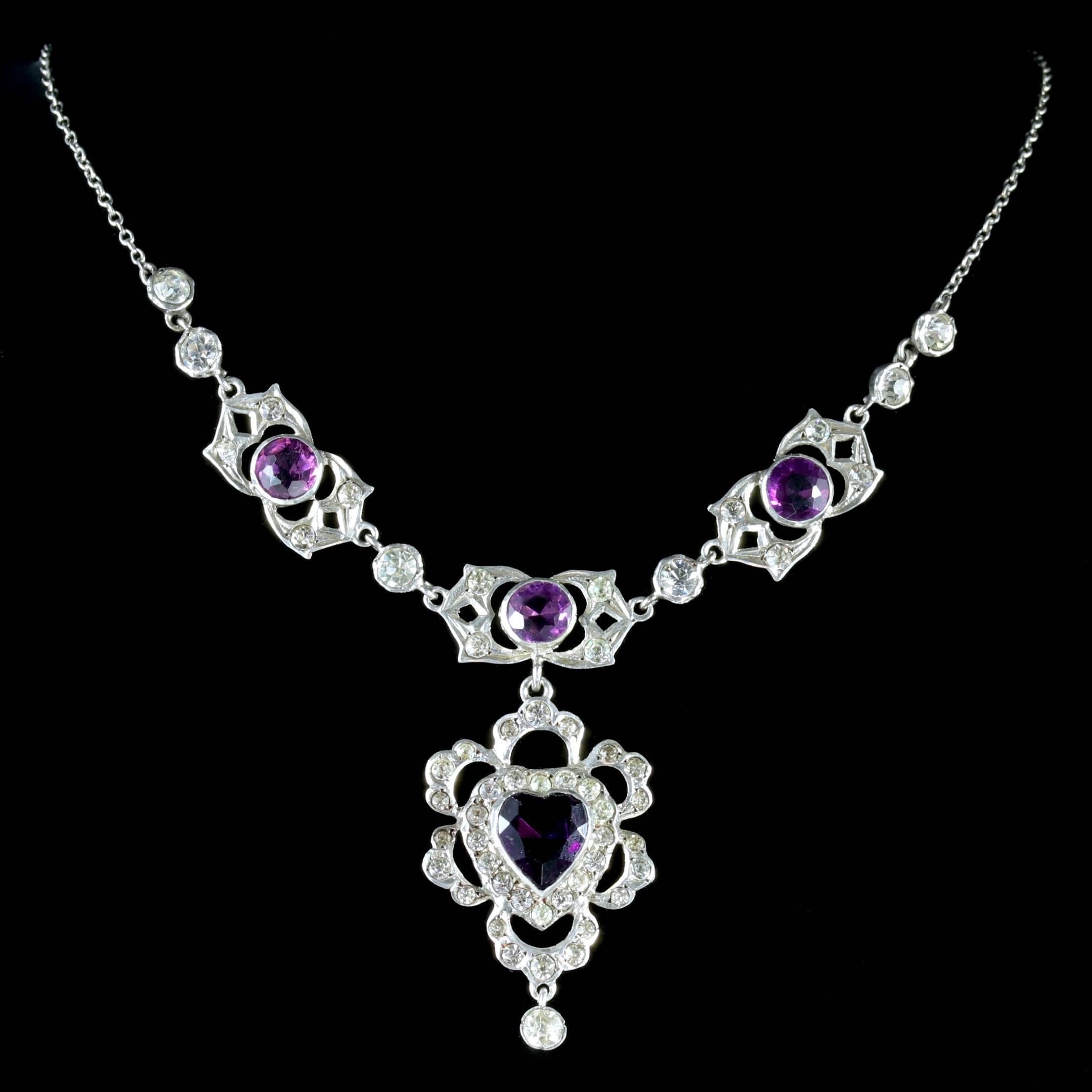 To read more please click continue reading below-

This fabulous antique Silver and Paste Lavaliere Necklace is genuine Victorian Circa 1900. 

The beautiful necklace is decorated with sparkling white and Purple Paste stones leading to a pretty