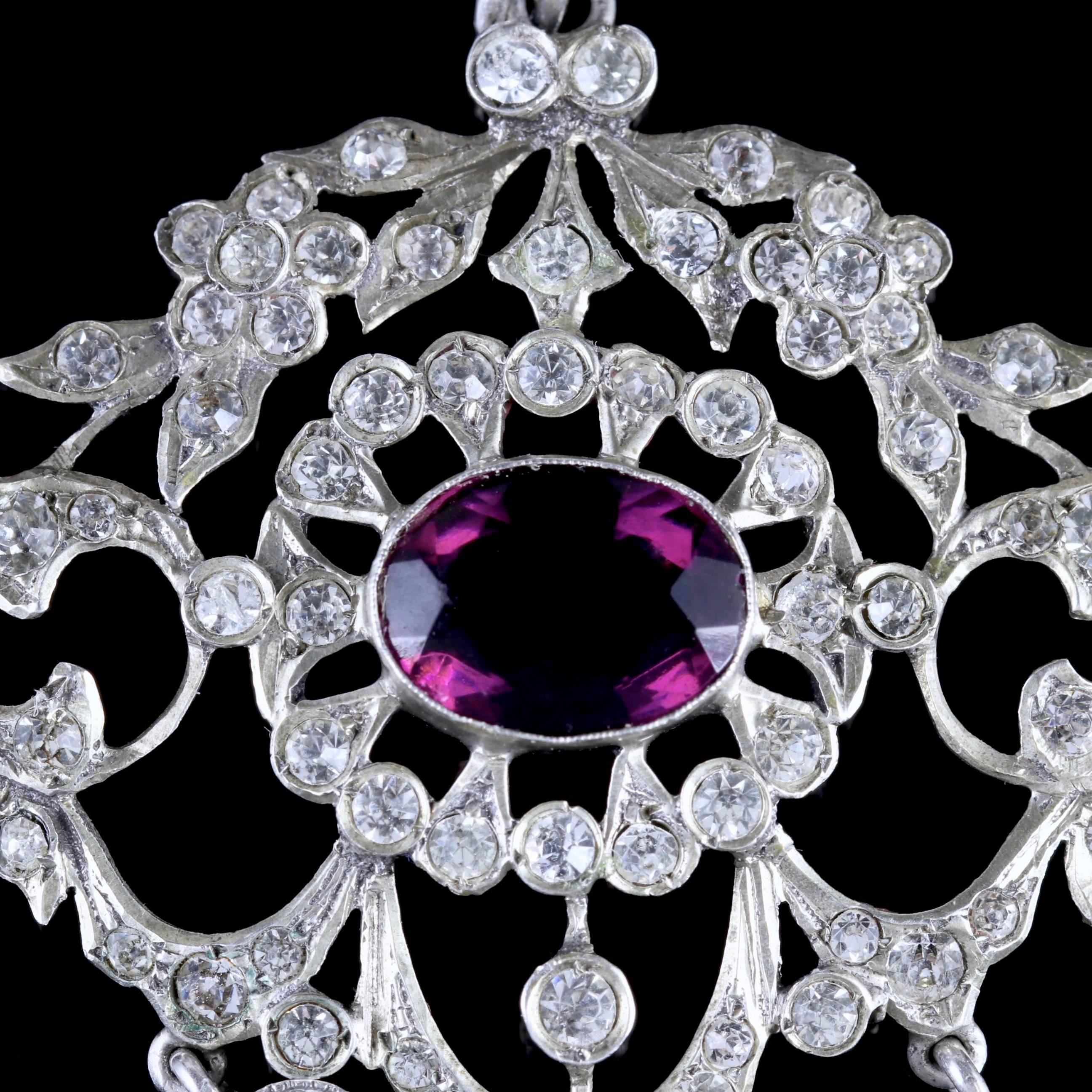 To read more please click continue reading below-

This fabulous antique Victorian Sterling Silver Paste pendant is Circa 1900. 

The pendant is adorned with a large Amethyst purple Paste Stone in the centre and decorated with sparkling white Pastes