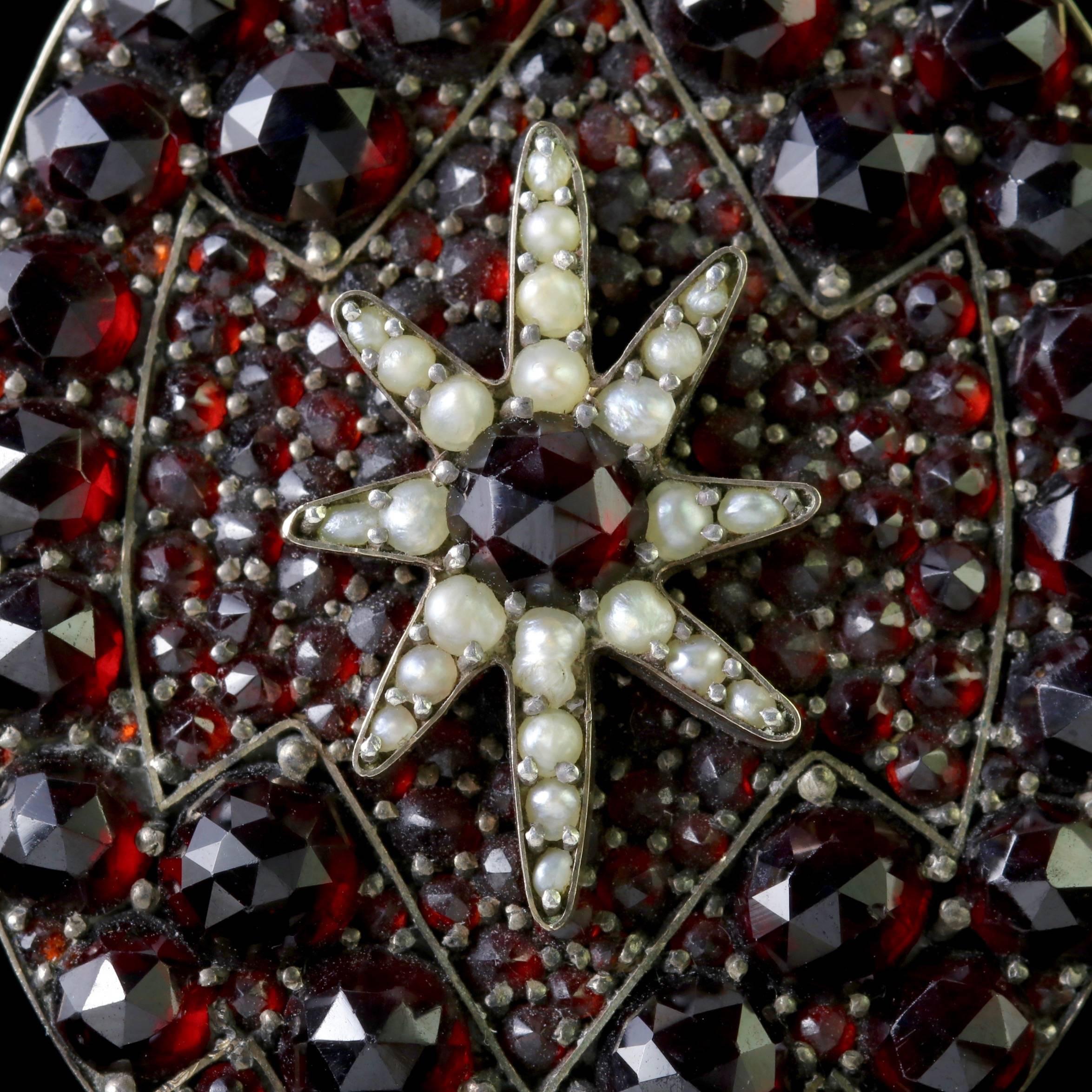 To read more please click continue reading below-

This beautiful antique Victorian Bohemian Garnet pendant locket is Circa 1880.

The wonderful pendant is encrusted with fabulous deep red Bohemian Garnet’s with a pretty Pearl Star in the centre.