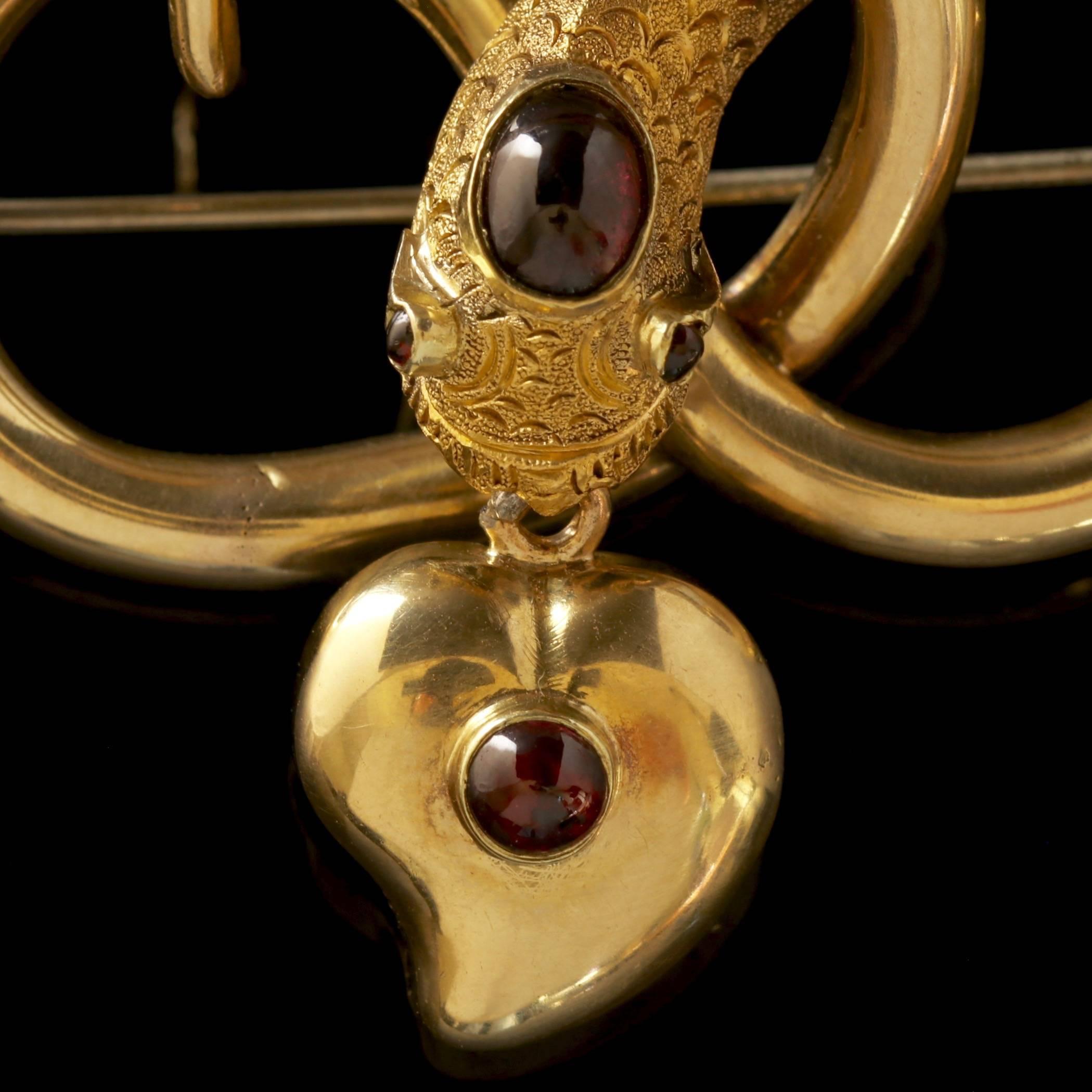 To read more please click continue reading below-

This fabulous antique Georgian 18ct Yellow Gold Garnet snake and Mourning witches heart brooch is Circa 1800.

Mourning jewellery mirrored the lives and times of the people who wore it. It was a