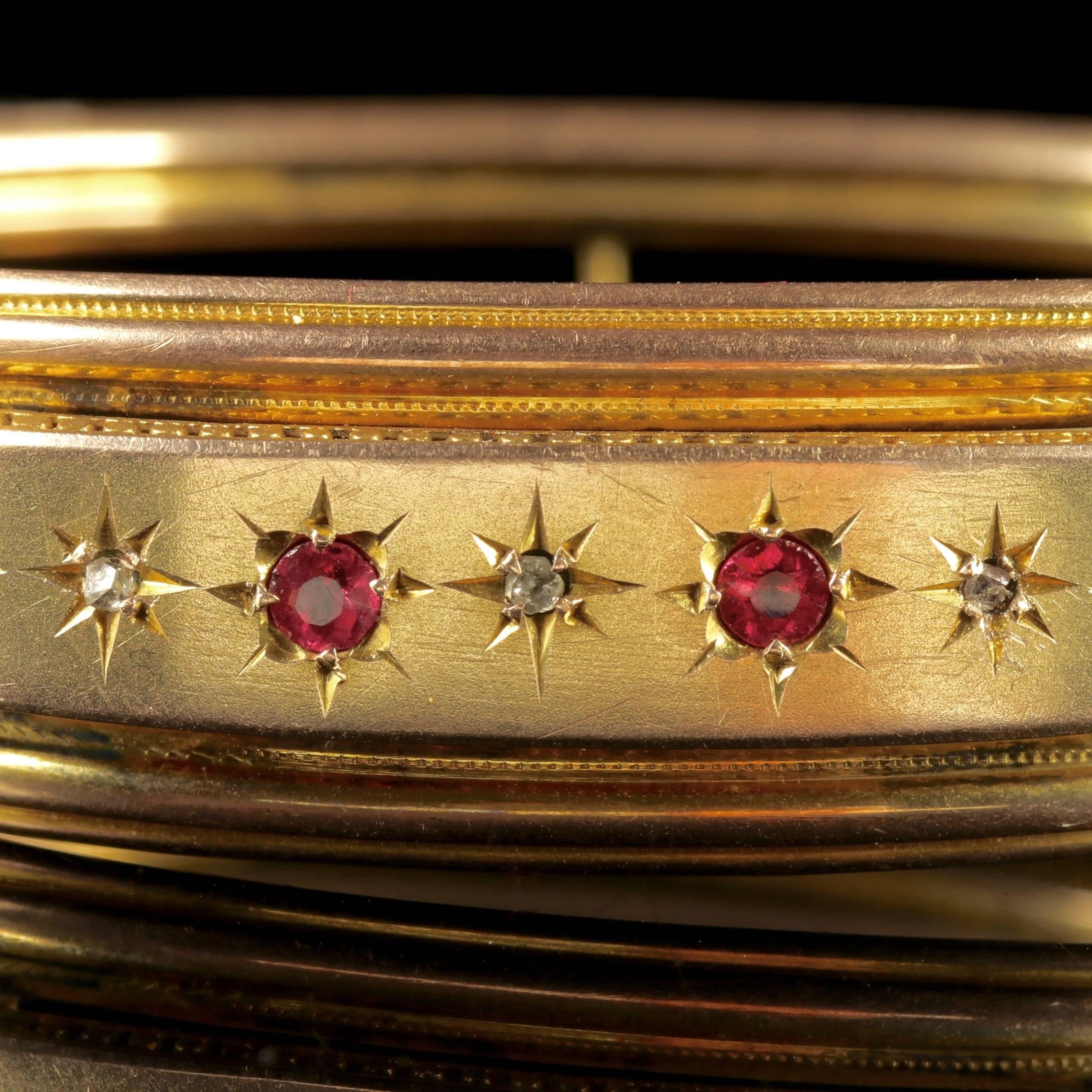 To read more please click continue reading below-

This beautiful antique Victorian 9ct Yellow Gold Ruby and Diamond bangle is Circa 1900. 

The bangle is adorned with four Star set Rubies across the front gallery that are 0.10ct each, complimented