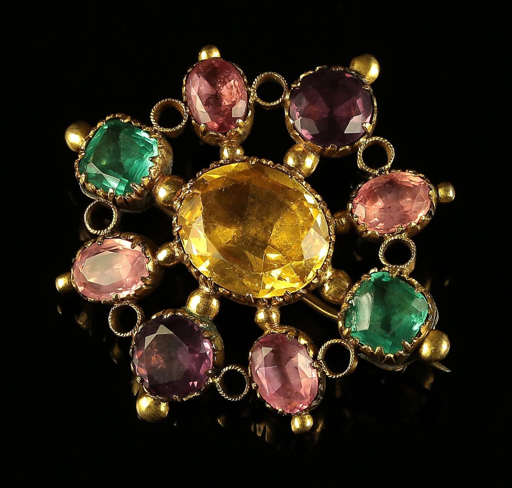 This very early Georgian harlequin gem set paste brooch is absolutely beautiful. 

Set with the most striking paste stones that have all been tested in 18ct gold gilt. 

The brooch is sterling silver gilded in 18ct gold. 

Paste stones sparkle