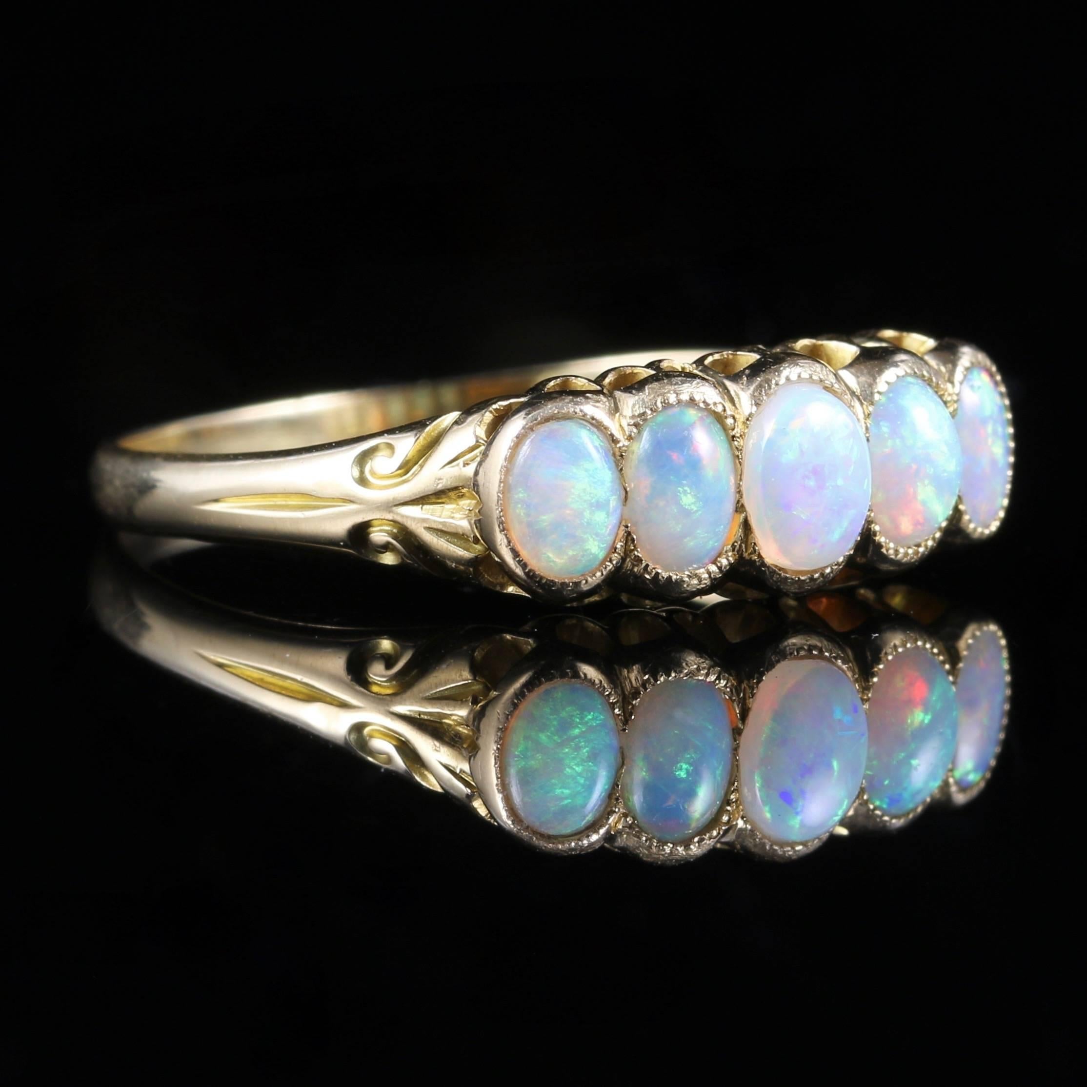 This fabulous Victorian ring is set with five lovely natural colourful opals, set in 18ct yellow gold and tested with jewellers acid. 

It is a genuine Victorian ring, Circa 1880. 

The lovely natural Opal is a kaleidoscope of rainbow colours