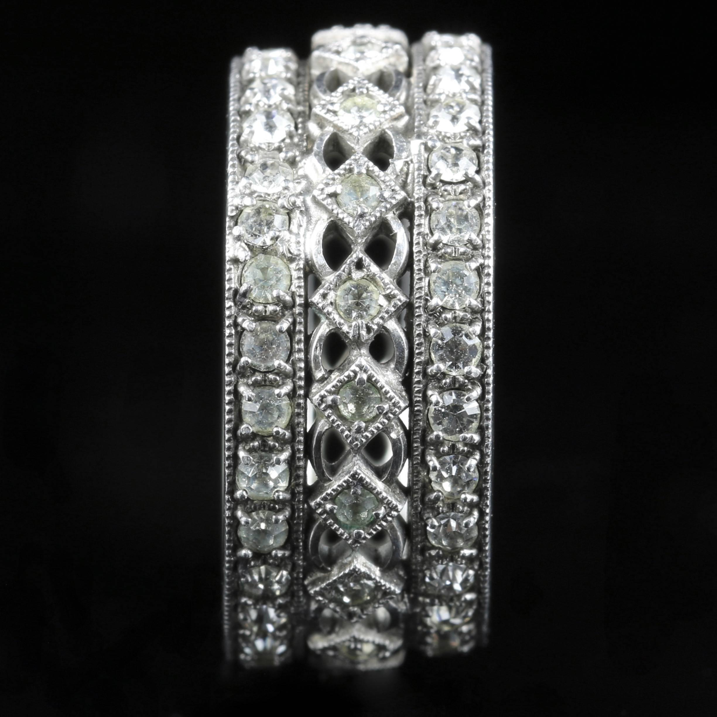This is fabulous, a genuine antique trilogy paste eternity band ring, Circa 1900. 

Set in Sterling Silver 

The paste stones sparkle around the gallery boasting a triple band. 

Paste is a heavy, very transparent flint glass that stimulates the