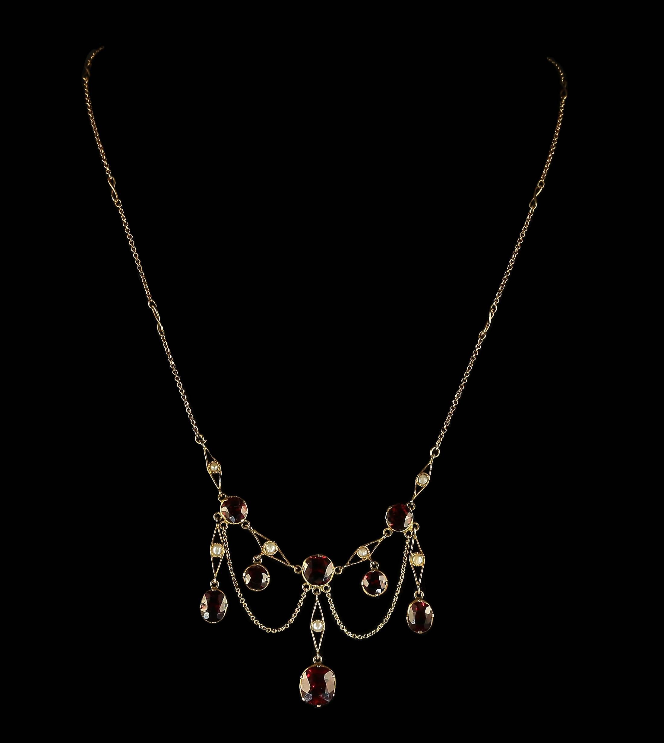 This fabulous 18ct yellow gold necklace is adorned with beautiful rich deep garnets and pearls.

The bottom garnet is 4ct alone, with swags of gold making a fabulous garland of garnets and pearls.

The necklace is fancy with lovely S panels around