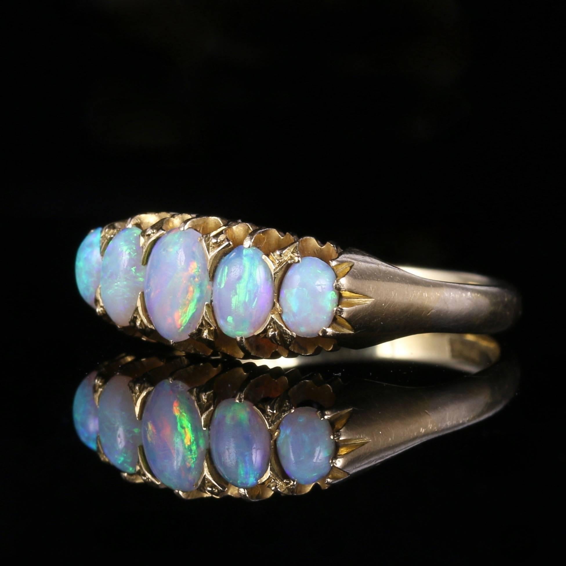 This fabulous Victorian ring is set with five lovely natural colourful opals, It is a genuine Victorian ring, Circa 1880.

This lovely colourful Opal ring is hallmarked 18ct gold inside the shank.

The striking natural Opals are a kaleidoscope of