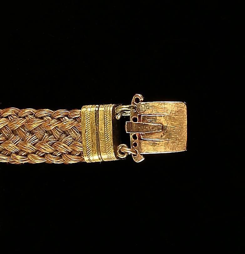 This lovely Antique Georgian gold mourning bracelet is set with a lovely pearl mourning clasp. 

Mourning jewellery mirrored the lives and times of the people who wore it.

It was a souvenir to remember a loved one, a reminder to the living of the
