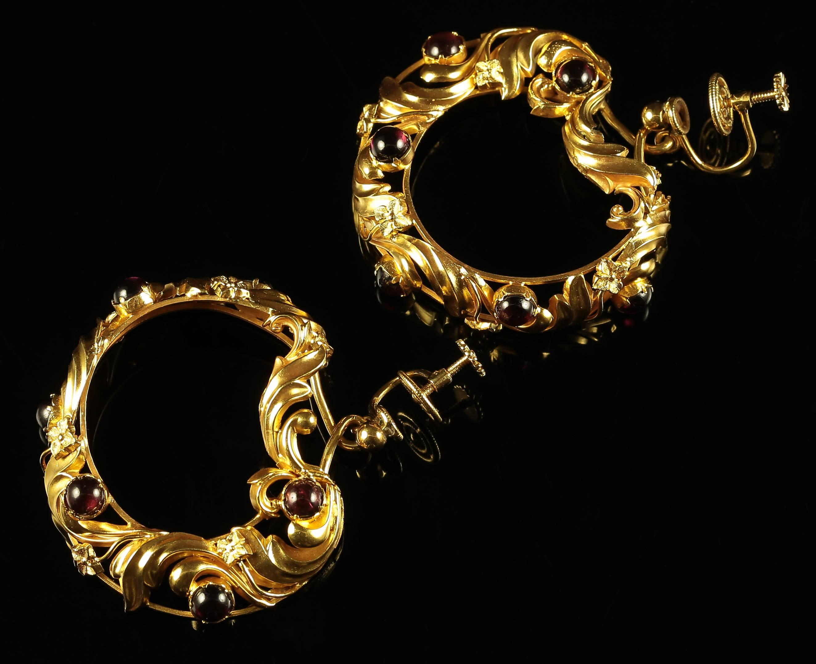 These 18ct yellow gold earrings are fabulous, large and exquisitely made with a matching brooch. 

Set in 18ct yellow gold displaying beautiful all round intertwined workmanship and lovely garnets 

The Garnet is a stone of purity and truth as well