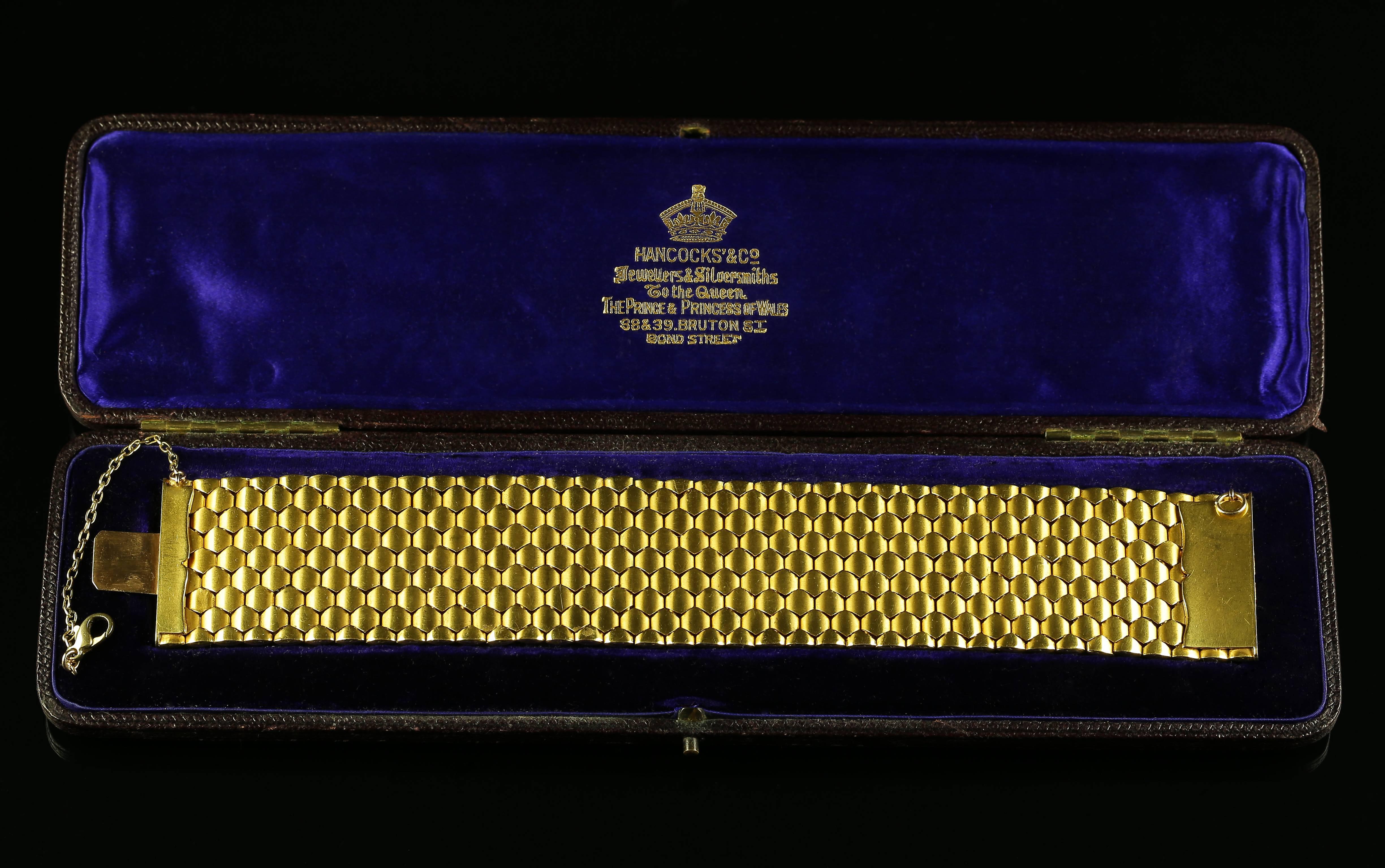 This magnificent Antique bracelet is solid 18ct gold in its original box.  

The bracelet comprises of exquisite gold workmanship from the jewellers Hancocks 

Hancock's is a Jeweller and Silver smith to the Queen, also The Prince and Princess of