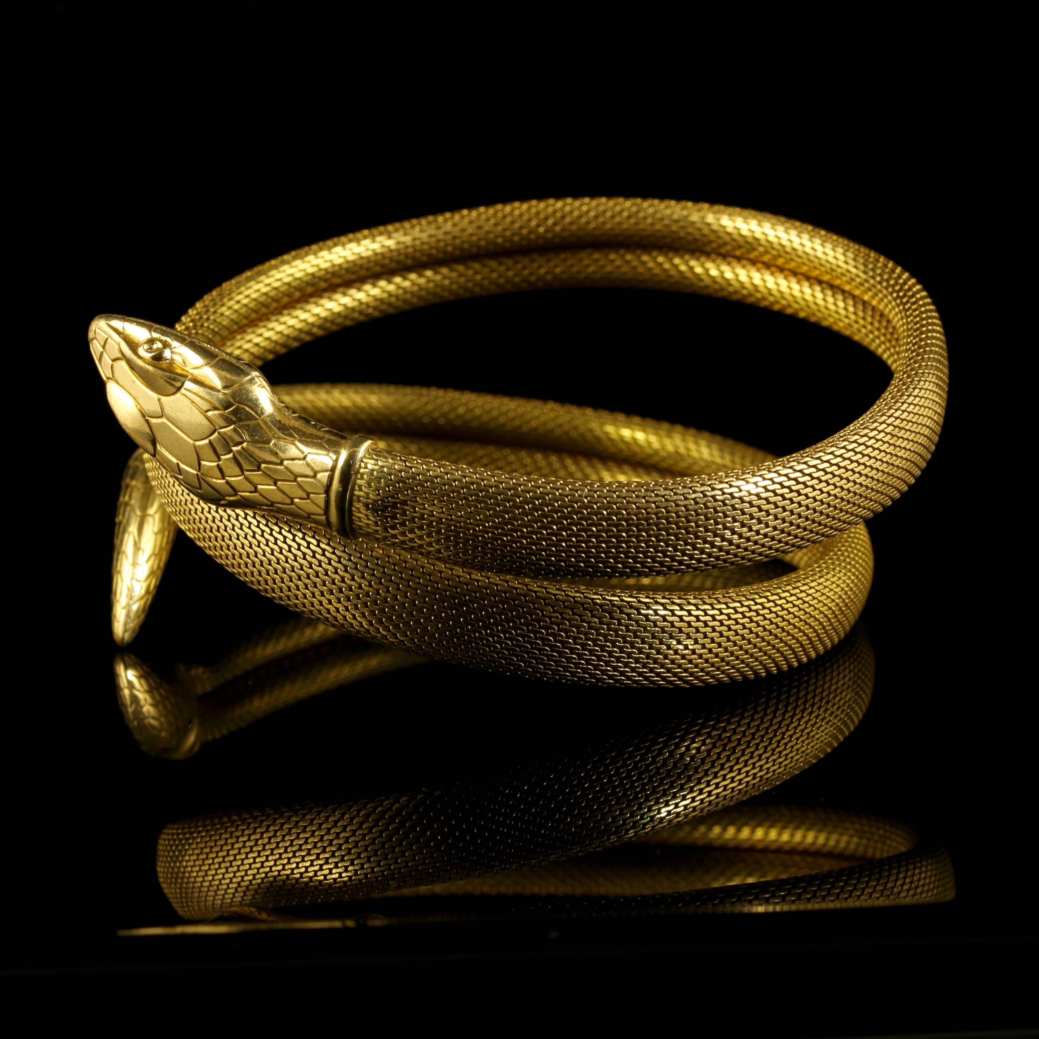 This genuine Victorian striking serpent bangle is Circa 1900

Set in silver and gilded in 18ct yellow gold.

Beautiful all round workmanship with engraved head and tail with a mesh body.

This beautiful bangle can be worn as a slave bangle or on the