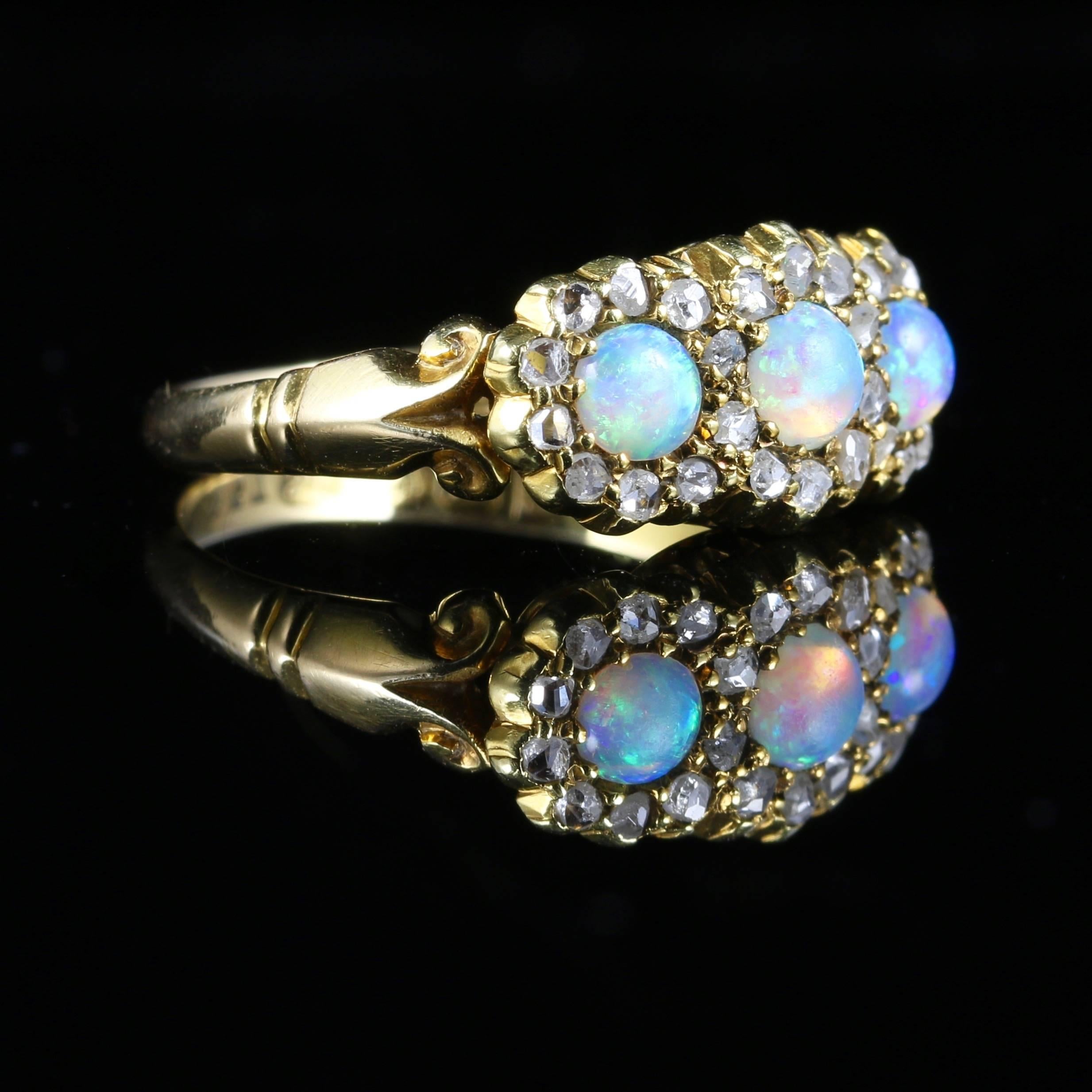 This wonderful Antique 18ct Victorian Opal and Diamond ring boasts three natural Opal gemstones that are truly stunning across the centre. 

This is a genuine original Antique ring set in 18ct yellow gold with Chester Hallmark. 

The Opals are a