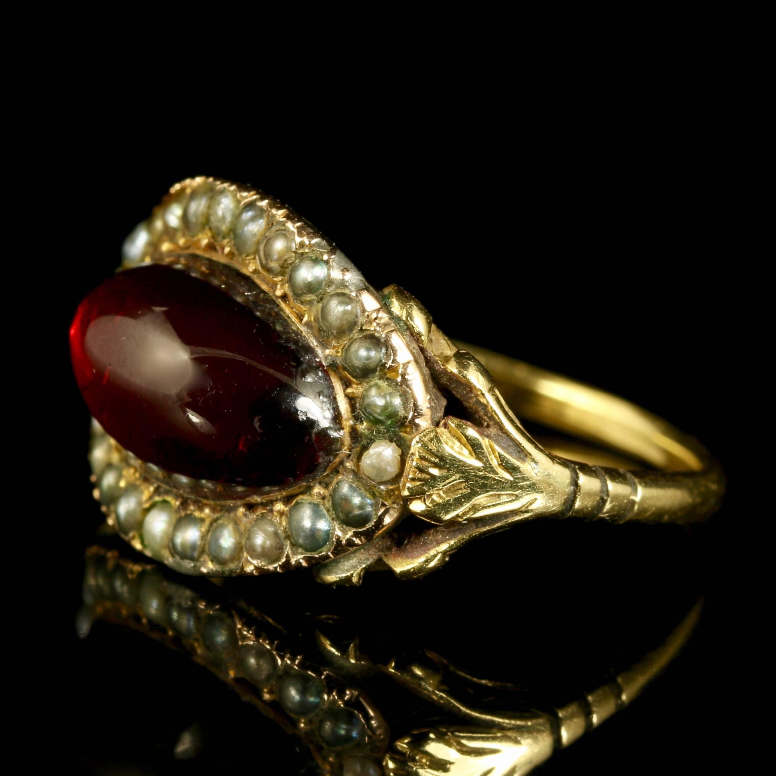 This is a stunning Georgian 18ct yellow gold ring, Circa 1800. 

The ring is set with fabulous Georgian workmanship from its time, boasting a deep rich red garnet surrounded by pearls.

The Garnet is a stone of purity and truth as well as a symbol