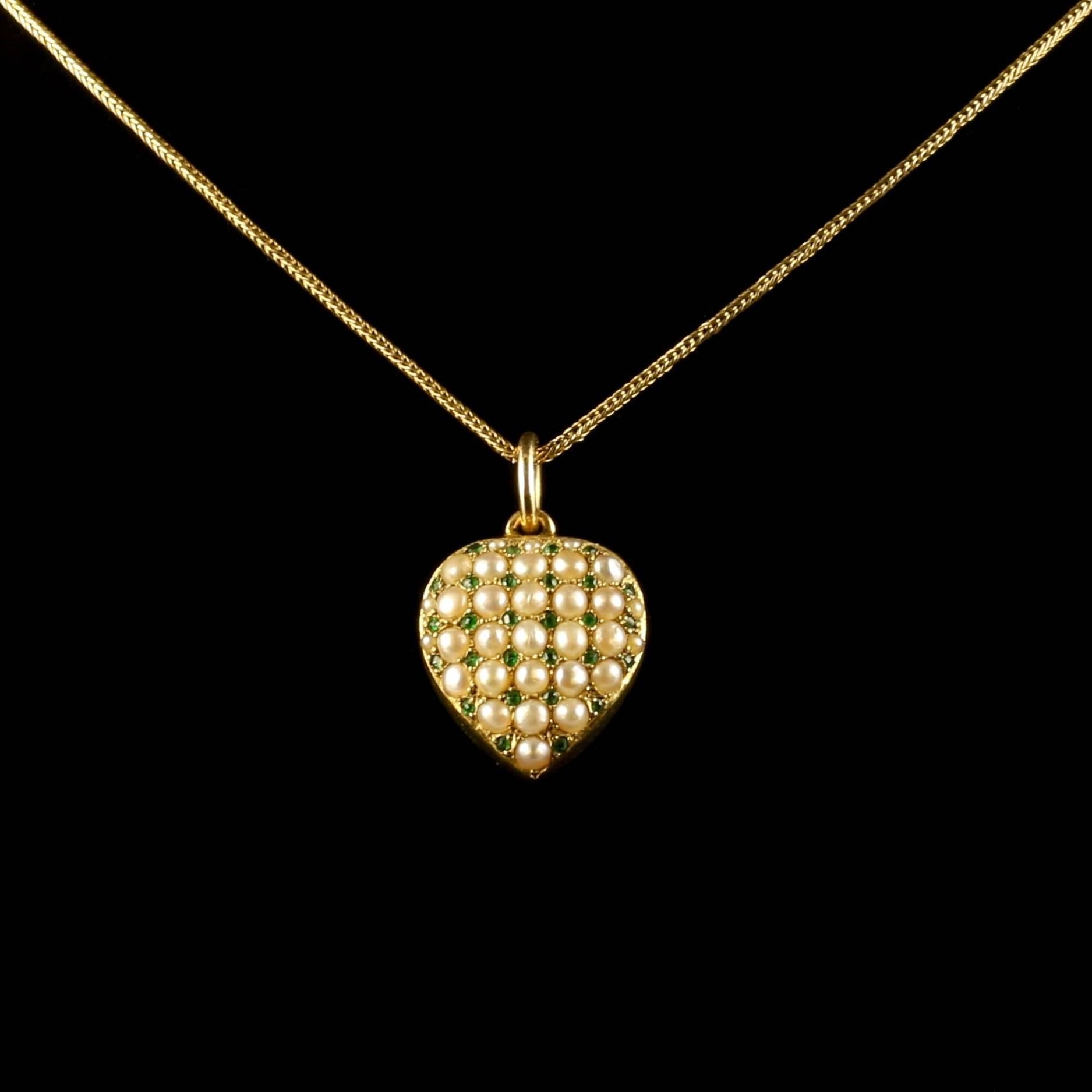 This fabulous Antique Victorian 18ct yellow gold locket and chain is outstanding.

Circa 1880.

A beautiful heart encrusted with natural pearls that compliment rich, green emeralds.

The fine chain is 18ct gold and goes beautifully with the stunning
