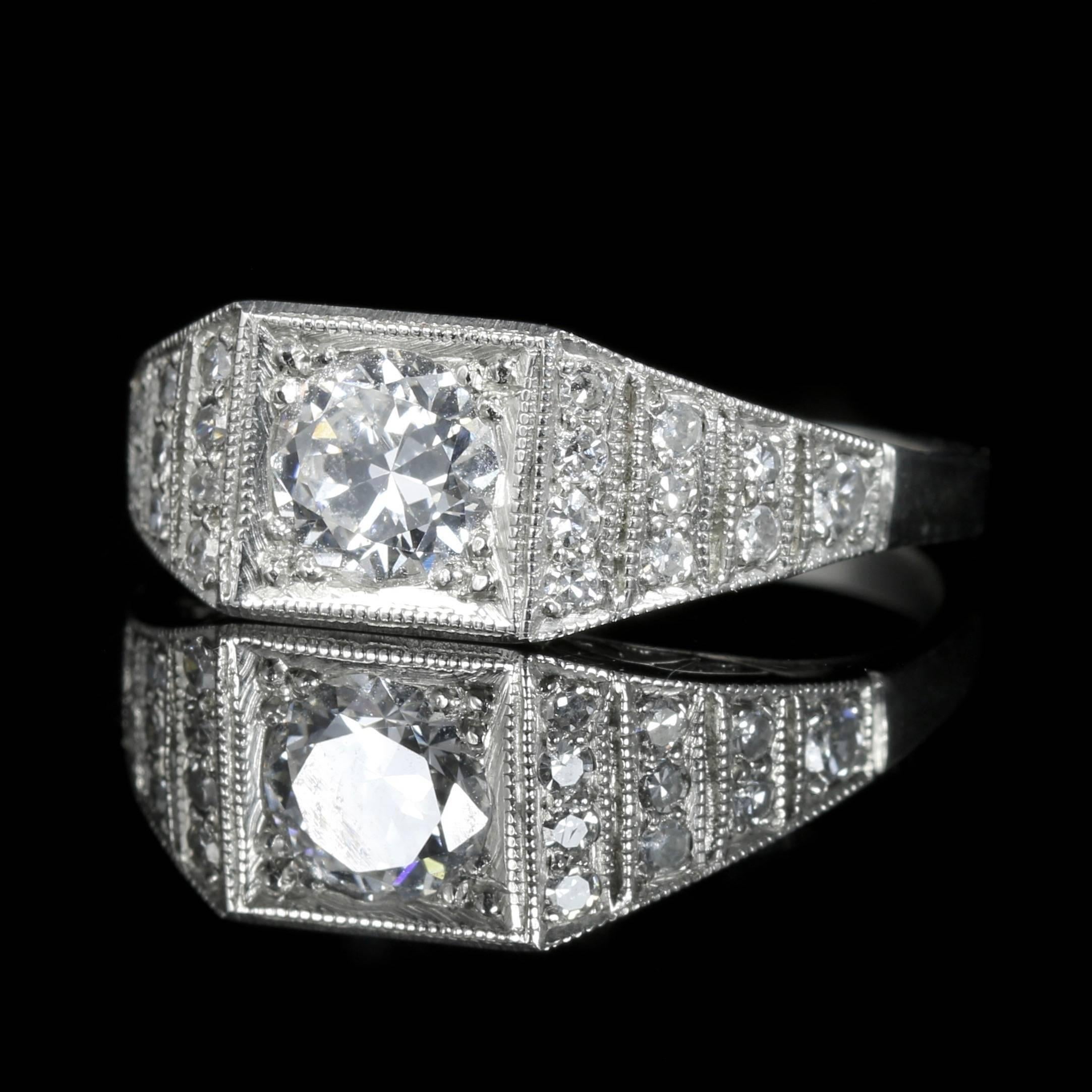 This beautiful Diamond all platinum ring is genuine 1920s set in a lovely Art Deco gallery that is all original.

The central Diamond is 0.92ct with smaller Diamonds encrusted into the outer gallery.

0.20ct of Diamonds sit on each shoulder, the