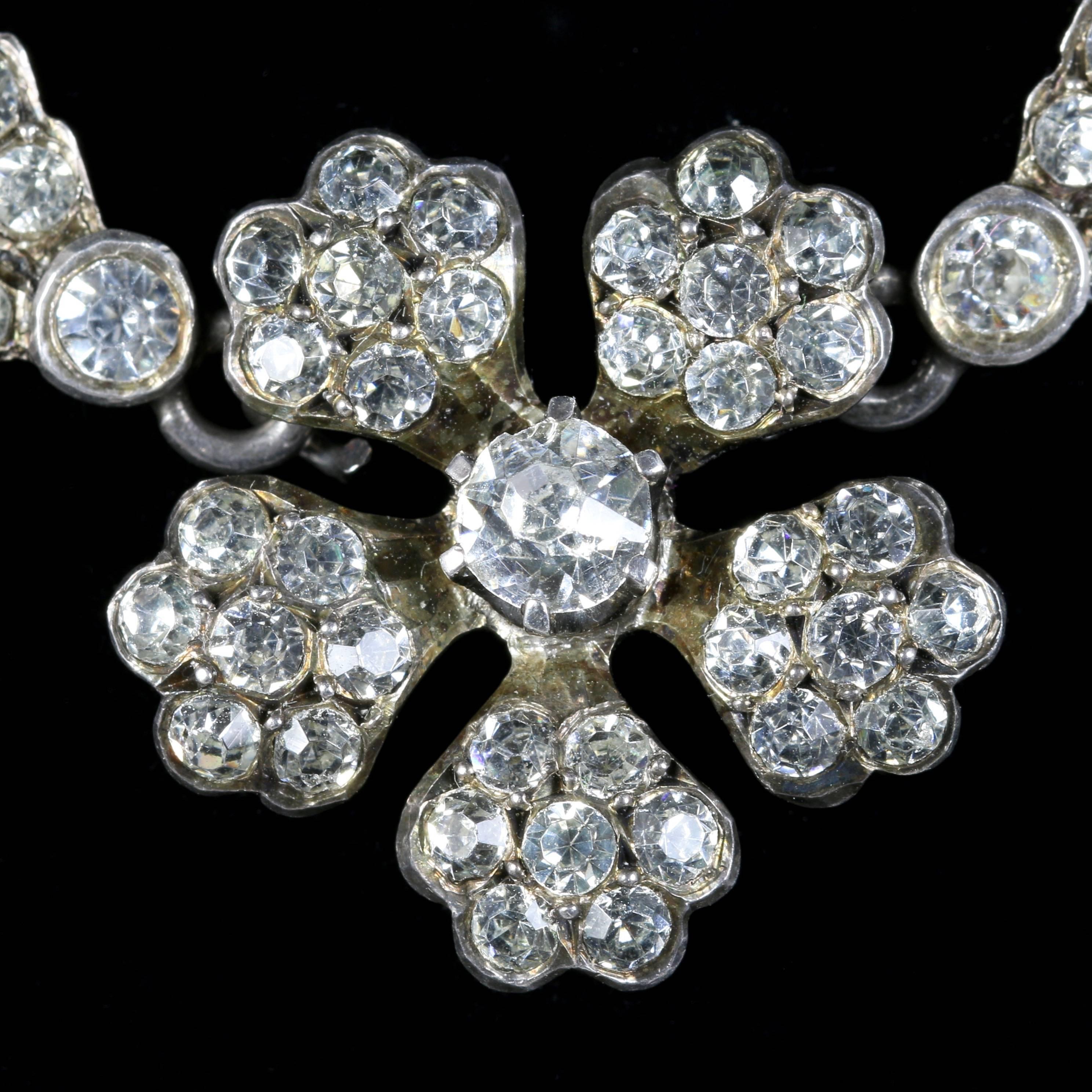 This spectacular Sterling Silver Antique Victorian Paste necklace is Circa 1810.

Steeped in English history, purchased in London.

This fabulous Necklace is set with sparkling Paste stones that lead to a floral central pendant.

Paste jewellery was