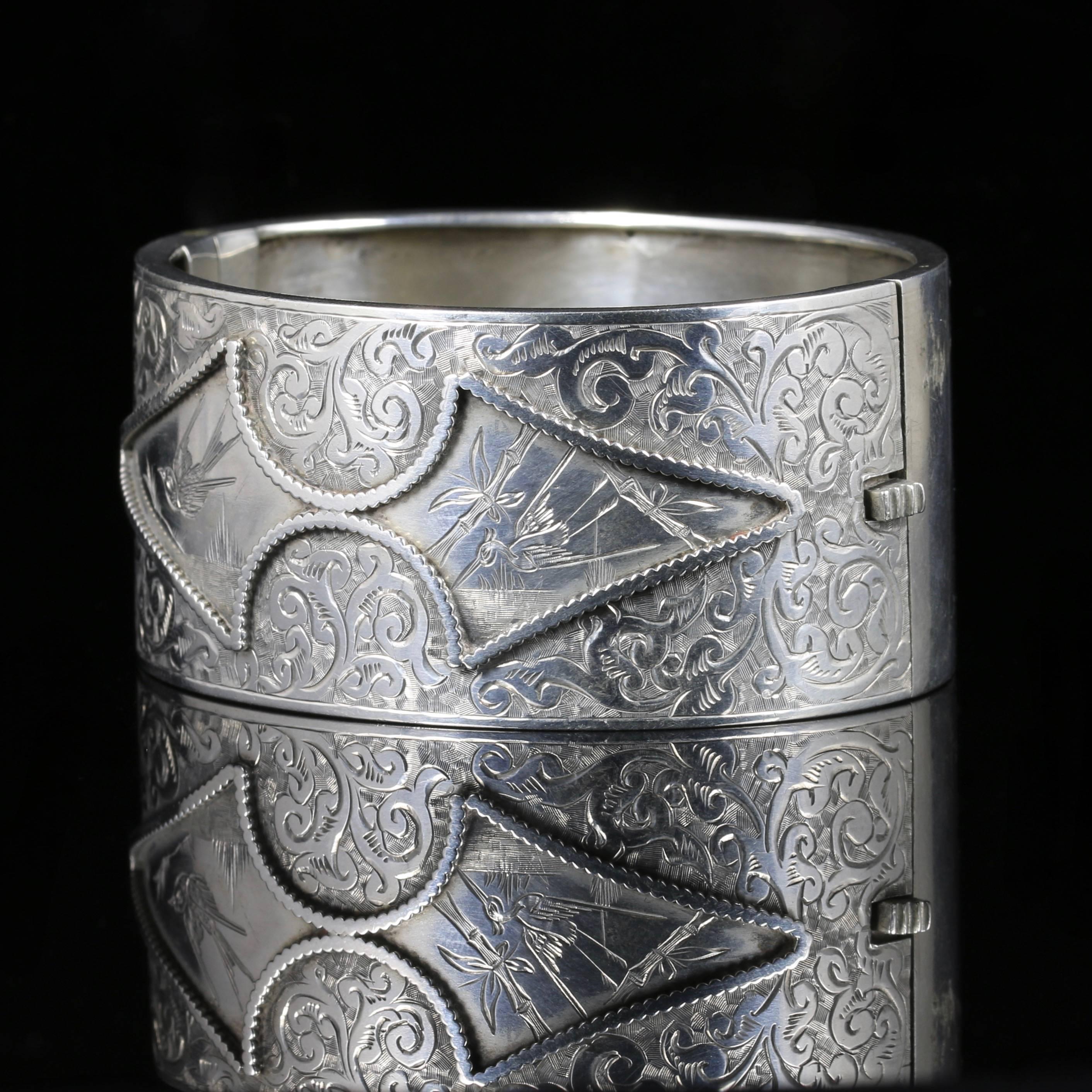 This beautiful sterling Silver wide cuff bangle is steeped in English history, purchased in London.

Circa 1880

Set with lovely engraving across the top gallery which includes birds and folate detail.

There is an inscription on the under carriage