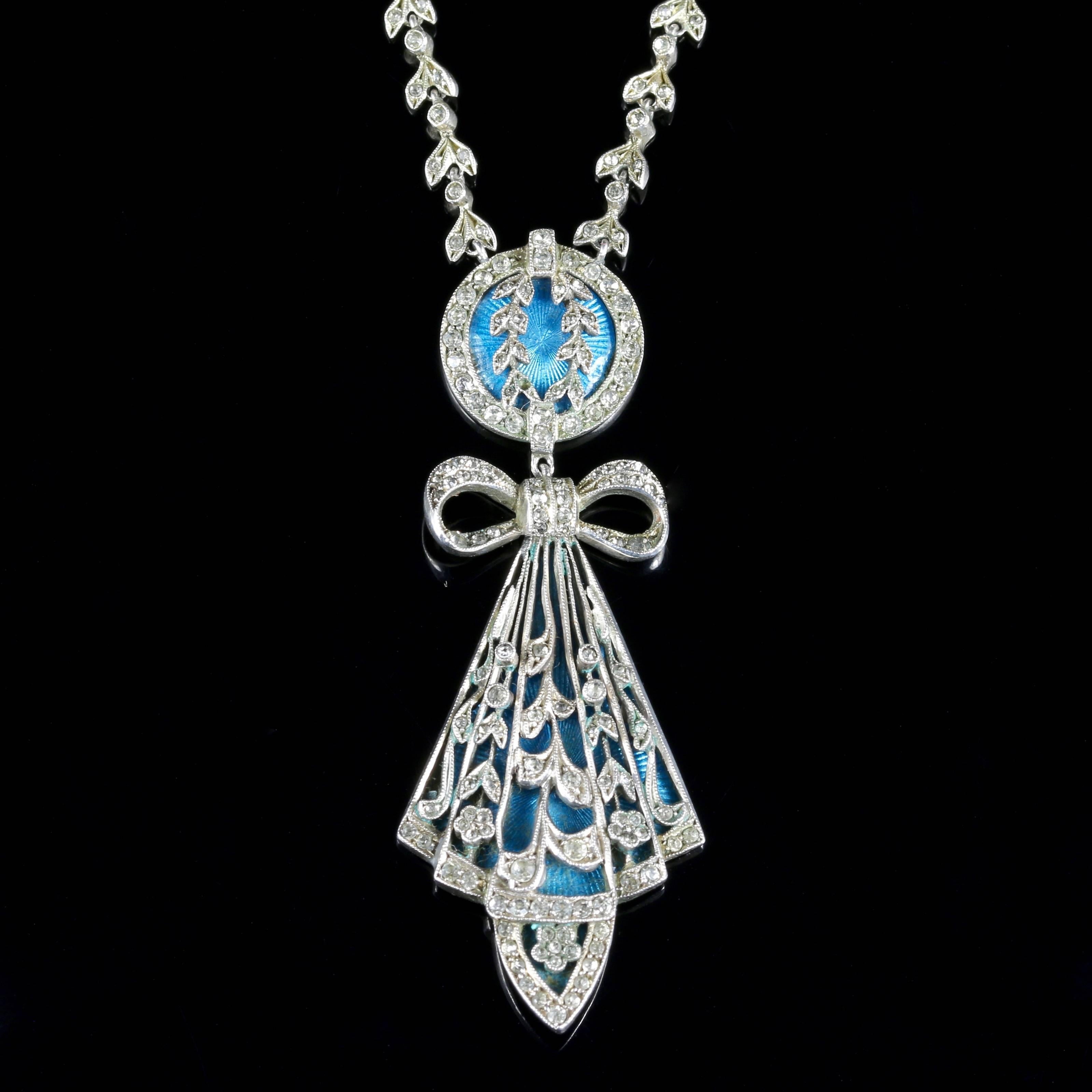 This very beautiful genuine Art Deco Sterling Silver necklace is set with beautiful blue enamel workmanship and Marcasite’s.

The bright turquoise enamelling colour strikes through the Silver workmanship, with a central Marcasite bow and deco