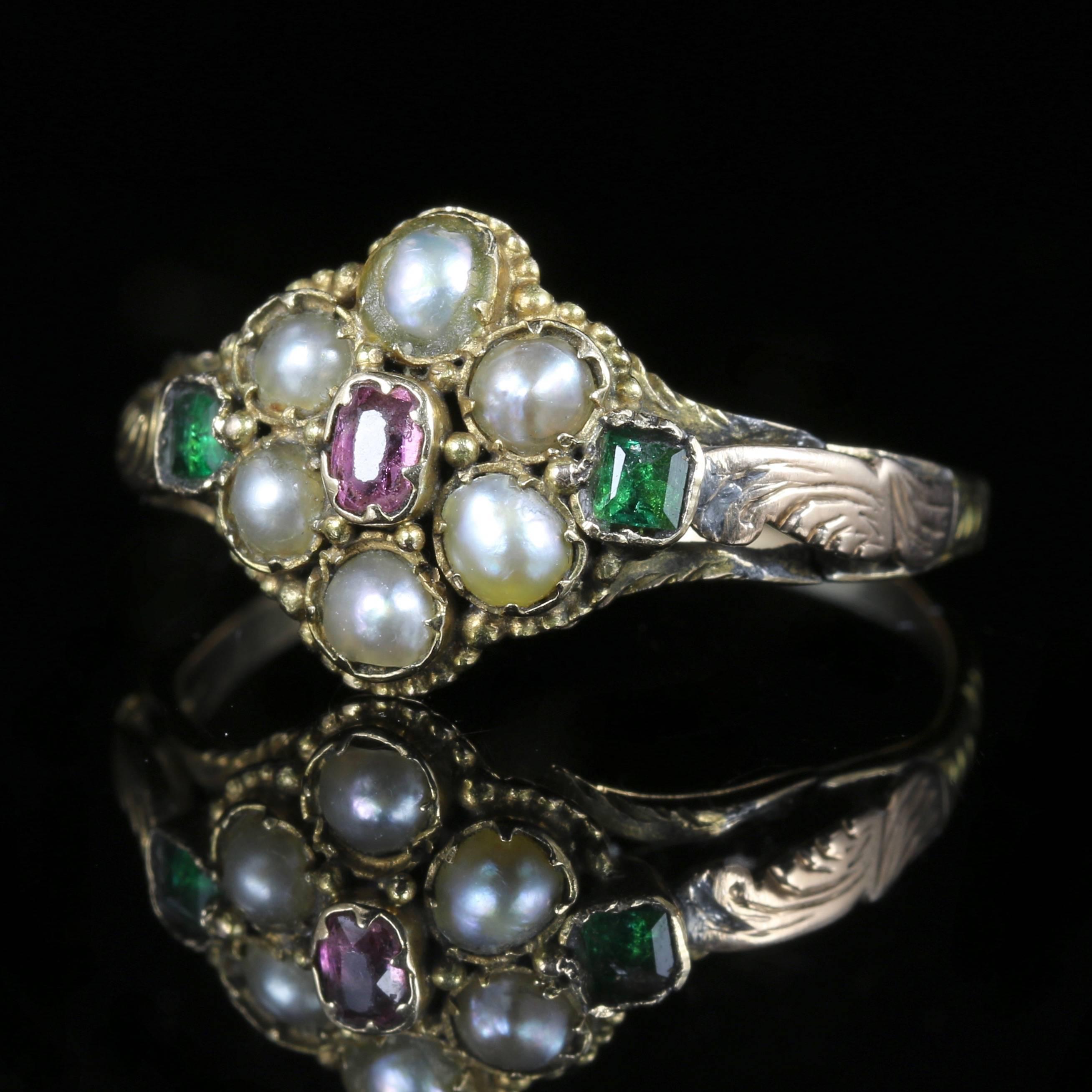 This is a stunning Georgian 18ct yellow Gold Antique ring, Circa 1800. Set with fabulous Georgian workmanship of its time, all original to the gallery and shank.

The central stone is an almandine Garnet, surrounded by Pearls and Emeralds.

This is
